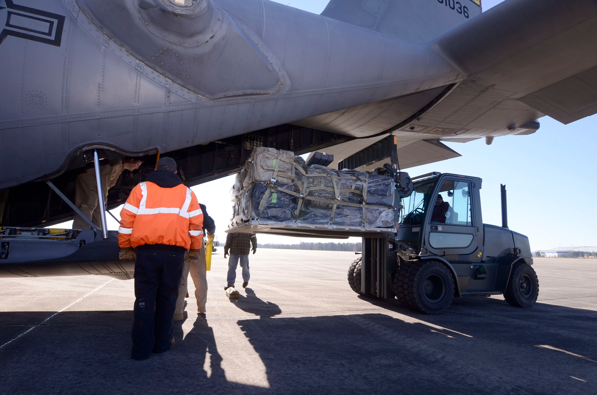 Members of the 94th Logistics Readiness Squadron, Dobbins Air Reserve Base, Ga. prepare and load cargo required by deployed personnel Jan. 6, 2015. Personnel appointed as inspector observe all aspects of the loading process ensuring all proper procedures are followed. (U.S. Air Force photo/Don Peek)
