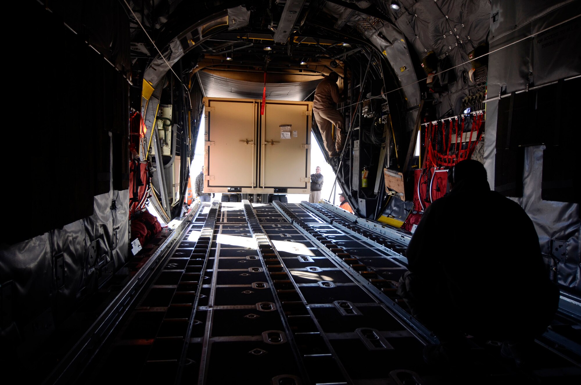 Members of the 94th Logistics Readiness Squadron, Dobbins Air Reserve Base, Ga. prepare and load cargo required by deployed personnel Jan. 6, 2015. Personnel appointed as inspector observe all aspects of the loading process ensuring all proper procedures are followed. (U.S. Air Force photo/Don Peek)