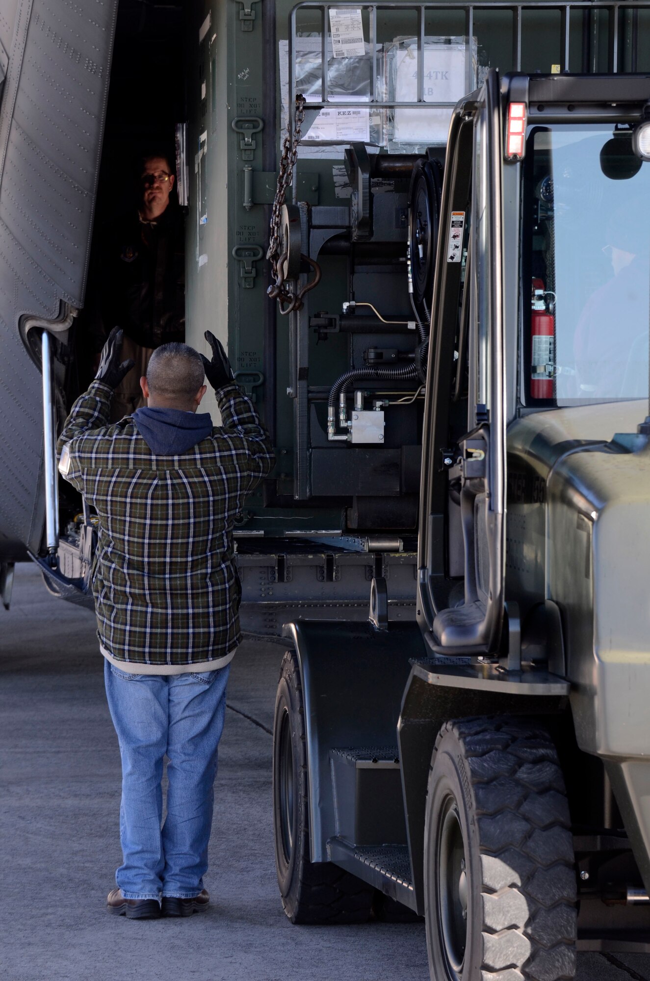 Members of the 94th Logistics Readiness Squadron, Dobbins Air Reserve Base, Ga. prepare and load cargo required by deployed personnel Jan. 6, 2015. Personnel appointed as inspector observe all aspects of the loading process ensuring all proper procedures are followed. (U.S. Air Force photo/Don Peek)