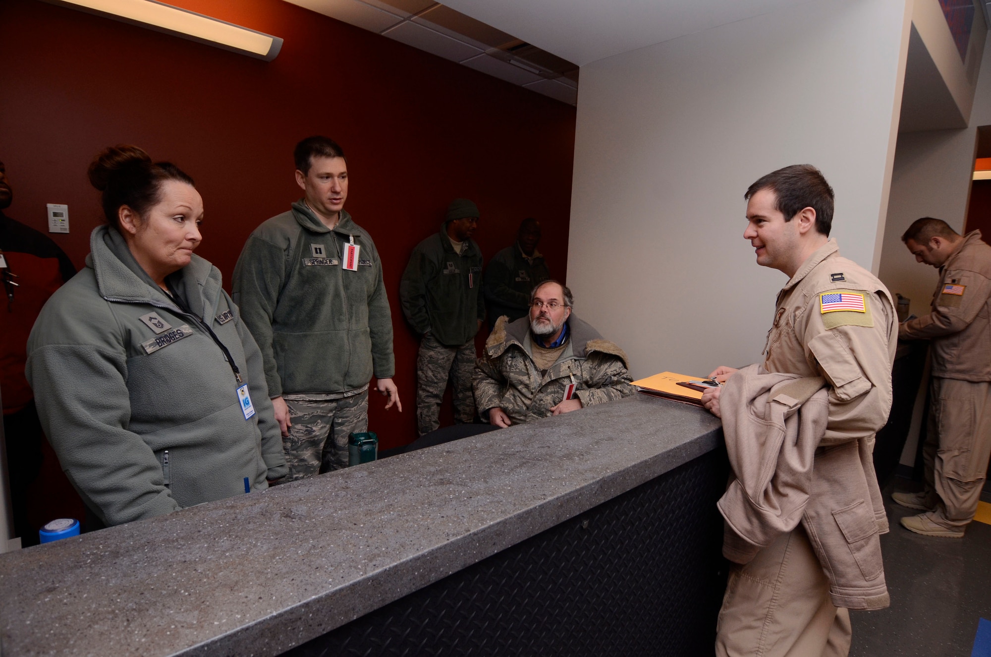 Inspector team members observe procedures during a personnel deployment processing line at Dobbins Air Reserve Base, Ga., Jan. 8, 2015. Personnel appointed as inspector observe all aspects of the loading process ensuring all proper procedures are followed. (U.S. Air Force photo/Don Peek)