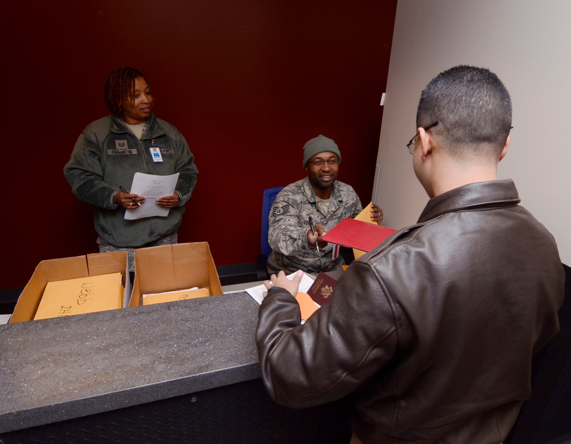 Inspector team members observe procedures during a personnel deployment processing line at Dobbins Air Reserve Base, Ga.,Jan. 8, 2015. Personnel appointed as inspector observe all aspects of the loading process ensuring all proper procedures are followed.  (U.S. Air Force photo/Don Peek)
