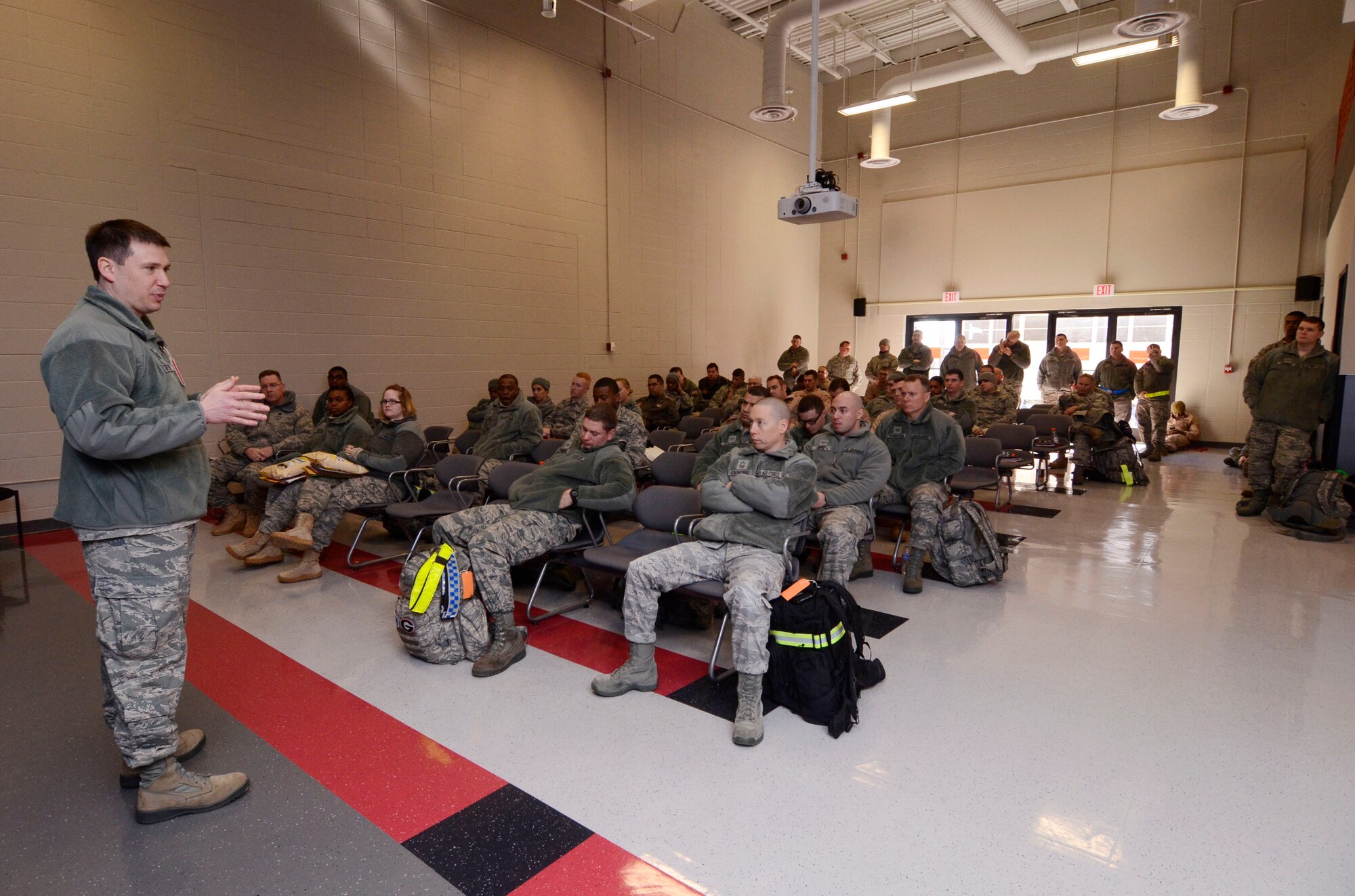 Deployment teams from Dobbins Air Reserve Base, Ga. receive a predeployment briefing, providing critical information required while in the Central Command Area of Responsibility Jan. 08, 2015. Assigned inspection teams observed various aspects of the deployment preparation while noting required process improvements. (U.S. Air Force photo/Don Peek)