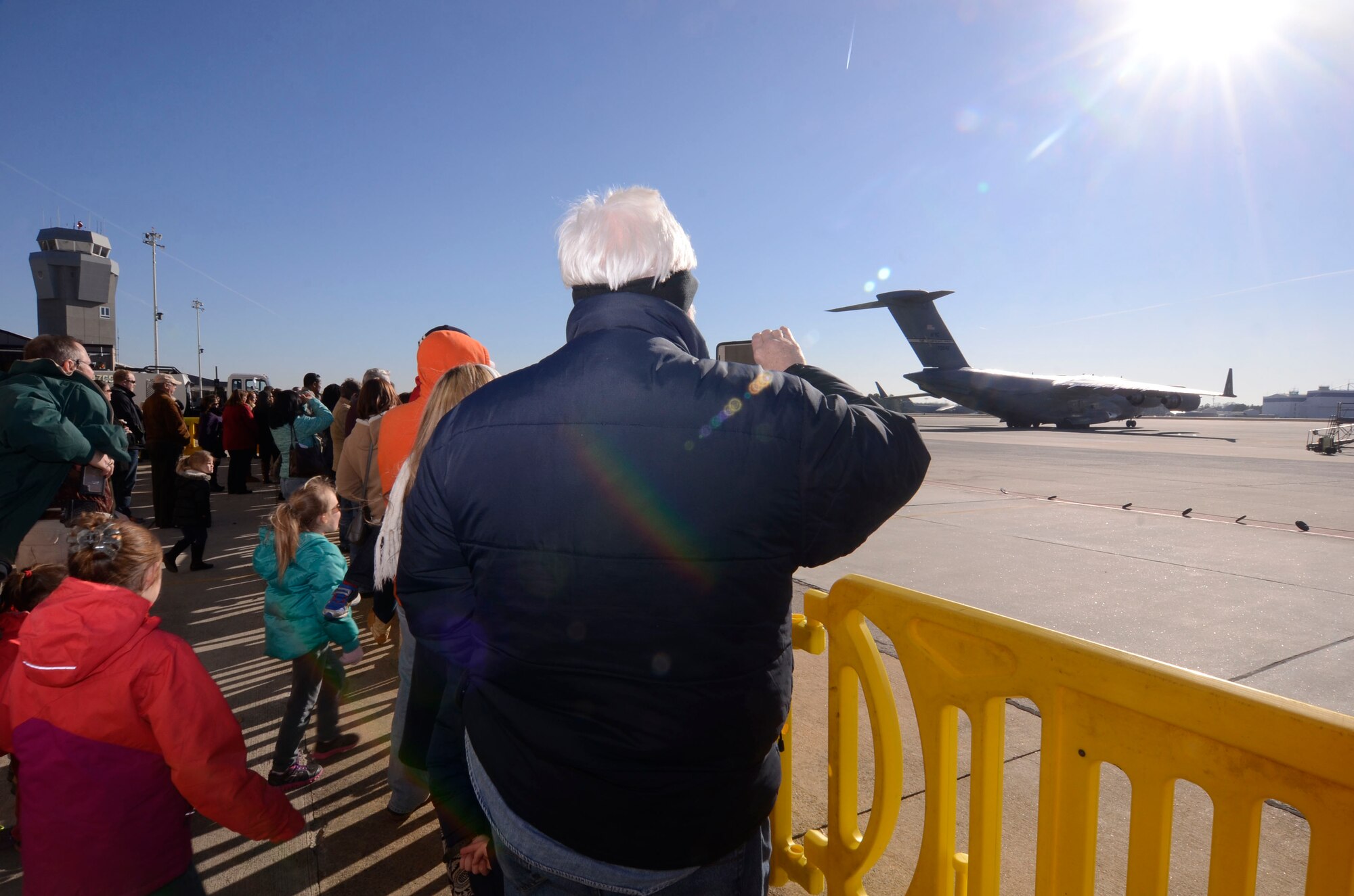 Family, friends and coworkers gather to wish deployment teams from Dobbins Air Reserve Base, Ga. well as the C-17 taking them to the Central Command Area of Responsibility taxis out, Jan. 8, 2015. During deployment preparations, inspection teams observed various operational procedures, noting any process improvements. (U.S. Air Force photo/Don Peek)