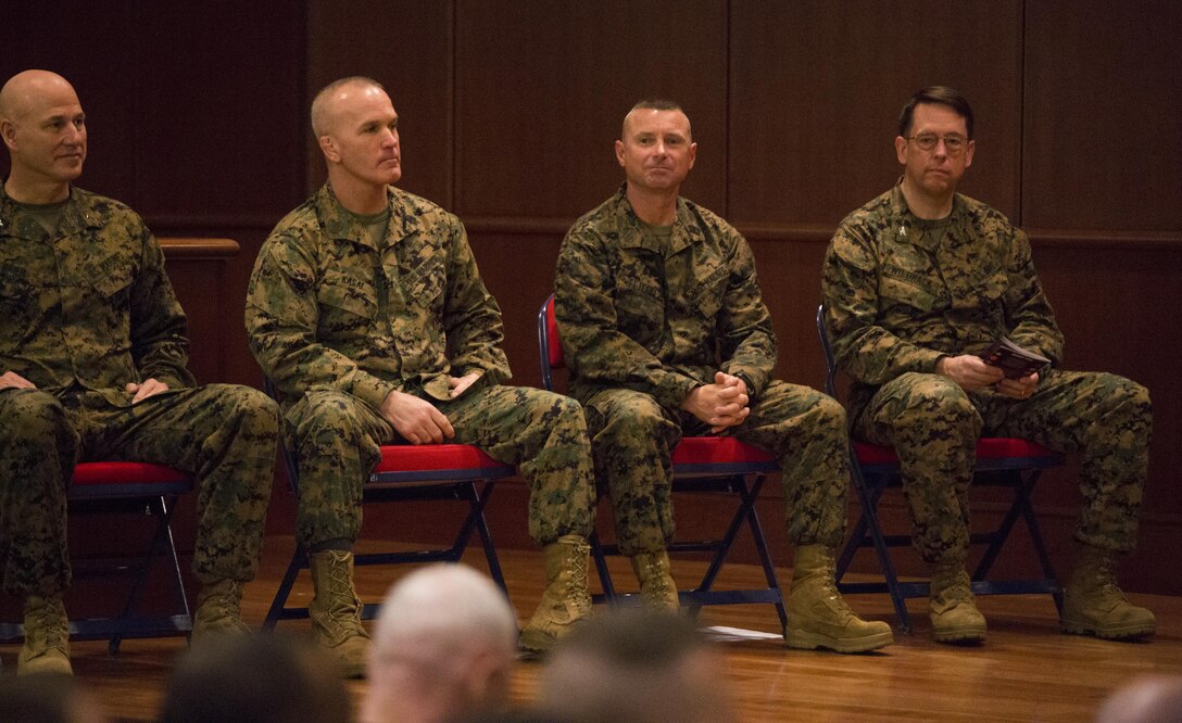 Sergeant Maj. Daniel Fliegel (second from the right), 4th Marine Divison sergeant major, prepares to officially take his post as the 4th MarDiv sergeant major, during a relief and appointment ceremony at Marine Corps Support Facility New Orleans, Feb. 26, 2015. During the ceremony, Marines welcomed Fliegel and bid farewell to Sgt. Maj. Bradley Kasal (second from the left) as he assumes his post as the new I Marine Expeditionary Force sergeant major. 