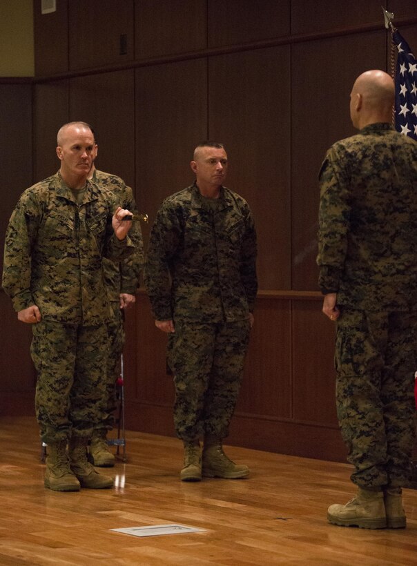 Sergeant Maj. Daniel Fliegel (center), 4th Marine Divison sergeant major, prepares to accept the noncommissioned officer sword from Sgt. Maj. Bradley Kasal (left), the previous 4th MarDiv sergeant major and current I Marine Expeditionary Force sergeant major, during a relief and appointment ceremony at Marine Corps Support Facility New Orleans, Feb. 26, 2015. During the ceremony, Marines welcomed Fliegel and said farewell to Kasal as he assumes his new post at I MEF. 