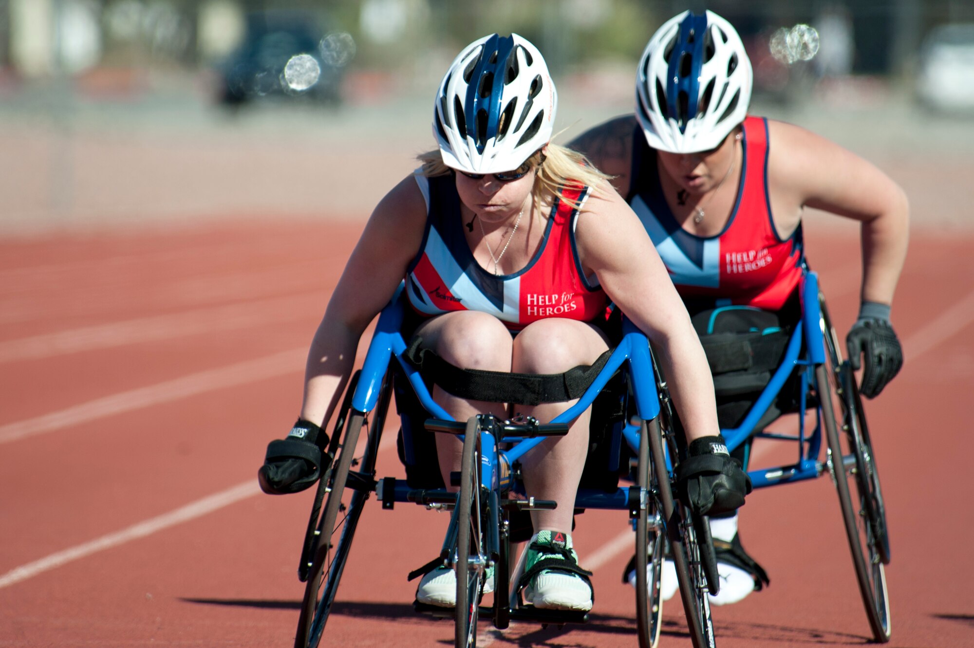 Anna Pollock leads Carolyne Dufley, both 2015 Help for Heroes track team members, at Nellis Air Force Base, Nev., March 3, 2015. Dufley later retook the lead to finish in first place at the end of the women’s 1500 meter wheelchair race. (U.S. Air Force photo by Senior Airman Timothy Young)