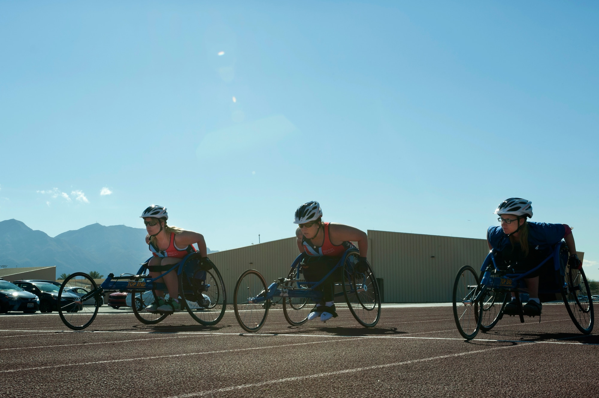 (From left to right) Anna Pollock, Carolyne Dufley and Kristina Morin, 2015 U.S. Air Force Trials participants, line up at the starting line prior to a race at Nellis Air Force Base, Nev., March 3, 2015. Dufley took first place, Pollock took a close second and Morin finished third. (U.S. Air Force photo by Senior Airman Timothy Young)