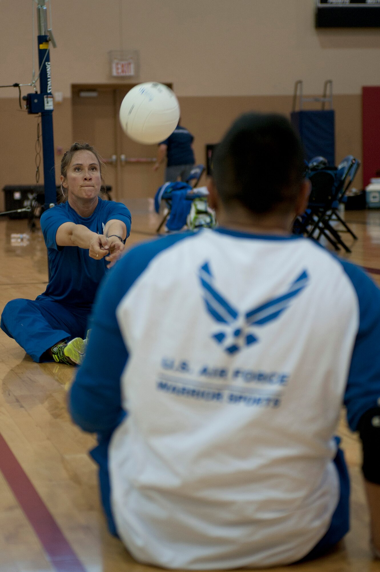 Angie Blue (left) and Steve Rasavongsy, 2015 U.S. Air Force Trials volleyball team members, practice hitting a volleyball at Nellis Air Force Base, Nev., March 2, 2015. More than 100 wounded, ill or injured service men and women from around the country will compete for a spot on the 2015 U.S. Air Force Wounded Warrior Team which will represent the Air Force at adaptive sports events throughout the year. (U.S Air Force photo by Senior Airman Timothy Young) 
