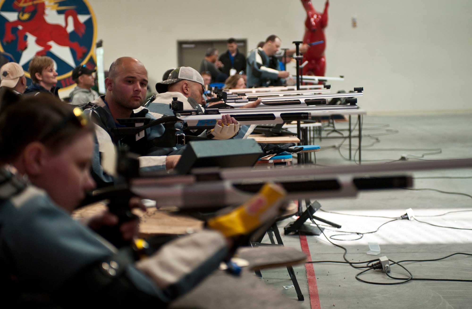 Participants in the 2015 U.S. Air Force Trials shoot at targets during the rifle shooting preliminary competition at Nellis Air Force Base, Nev., March 3, 2015. The Air Force Trials are an adaptive sports event designed to promote the mental and physical well-being of seriously ill and injured military members and veterans. (U.S. Air Force photo by Staff Sgt. Siuta B. Ika)