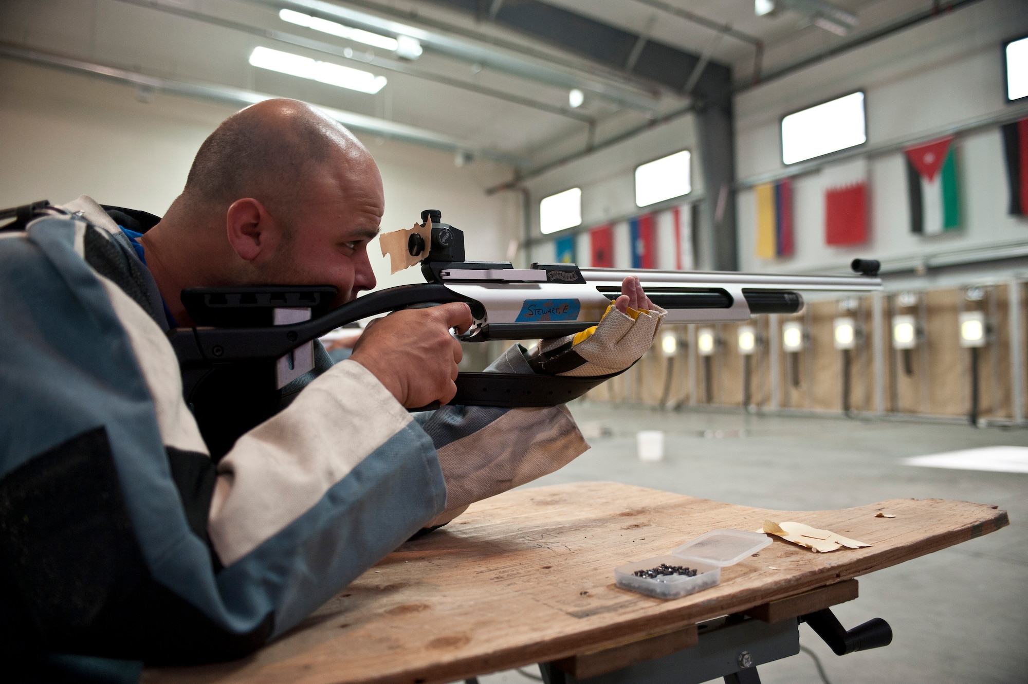Edward Newbern, 2015 U.S. Air Force Trials participant, aims at a target during the rifle shooting preliminary competition at Nellis Air Force Base, Nev., March 3, 2015. Participants in the trials will compete in wheelchair basketball, wheelchair rugby, sitting volleyball, swimming, track and field, air pistol and rifle shooting, archery and cycling. (U.S. Air Force photo by Staff Sgt. Siuta B. Ika)