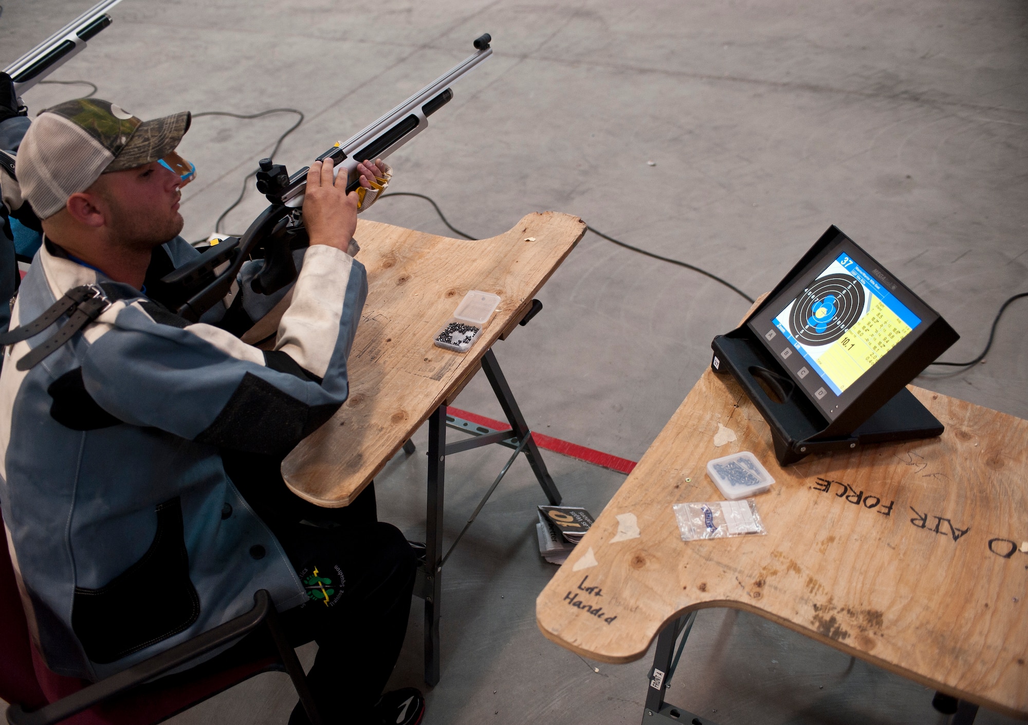 Edward Newbern, 2015 U.S. Air Force Trials participant, reloads his rifle during the rifle shooting preliminary competition at Nellis Air Force Base, Nev., March 3, 2015. During the trials, participants will be competing for a spot on the 2015 U.S. Air Force Wounded Warrior Team, which will represent the Air Force at adaptive sports events throughout the year.  (U.S. Air Force photo by Staff Sgt. Siuta B. Ika)