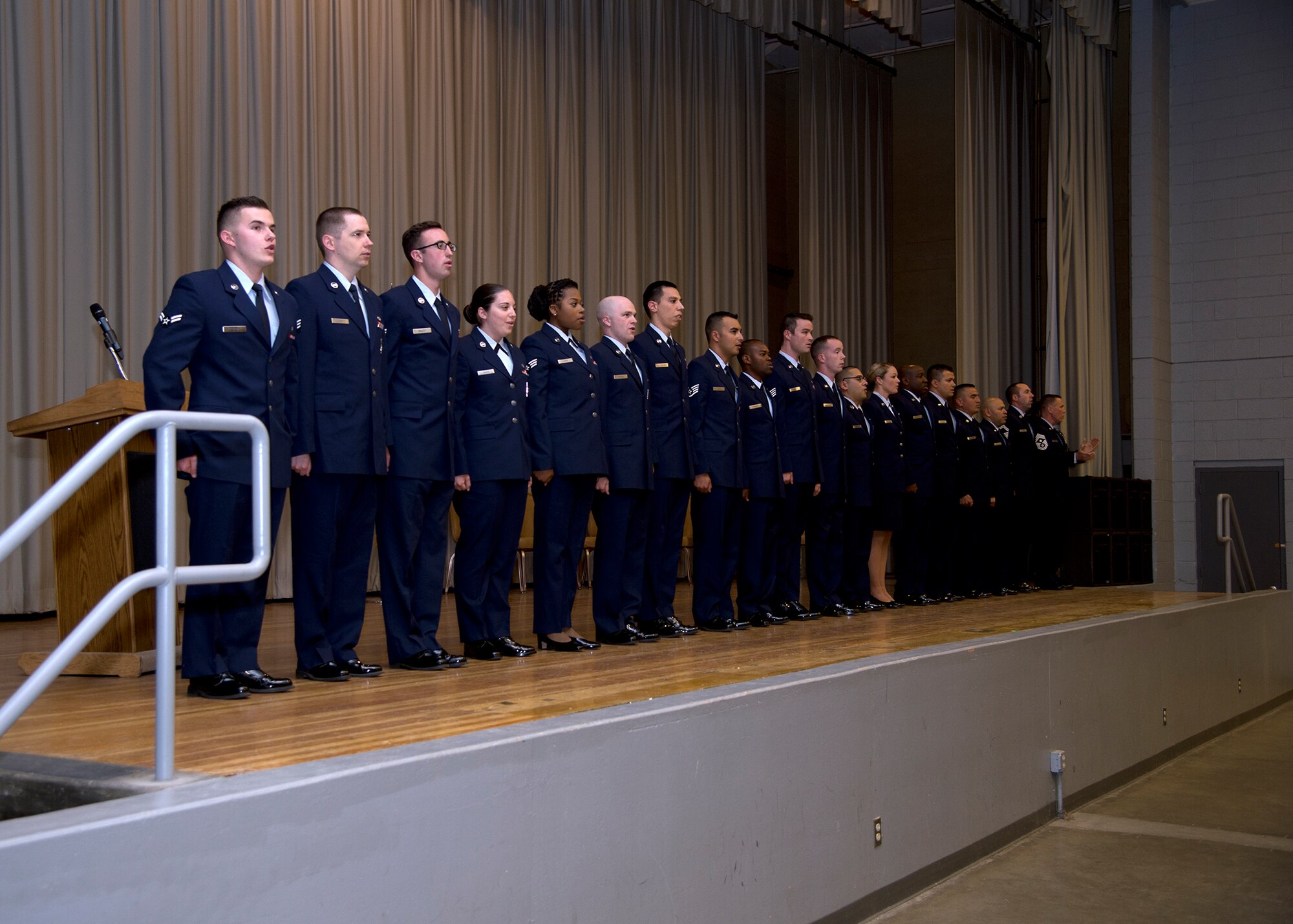 Team Edwards Airmen sing the "Air Force Song" during the monthly enlisted promotion ceremony in the base theater Feb. 27. The 412th Test Wing generally holds its monthly promotion ceremony the last day of the month. (U.S. Air Force photo by Ethan Wagner)
