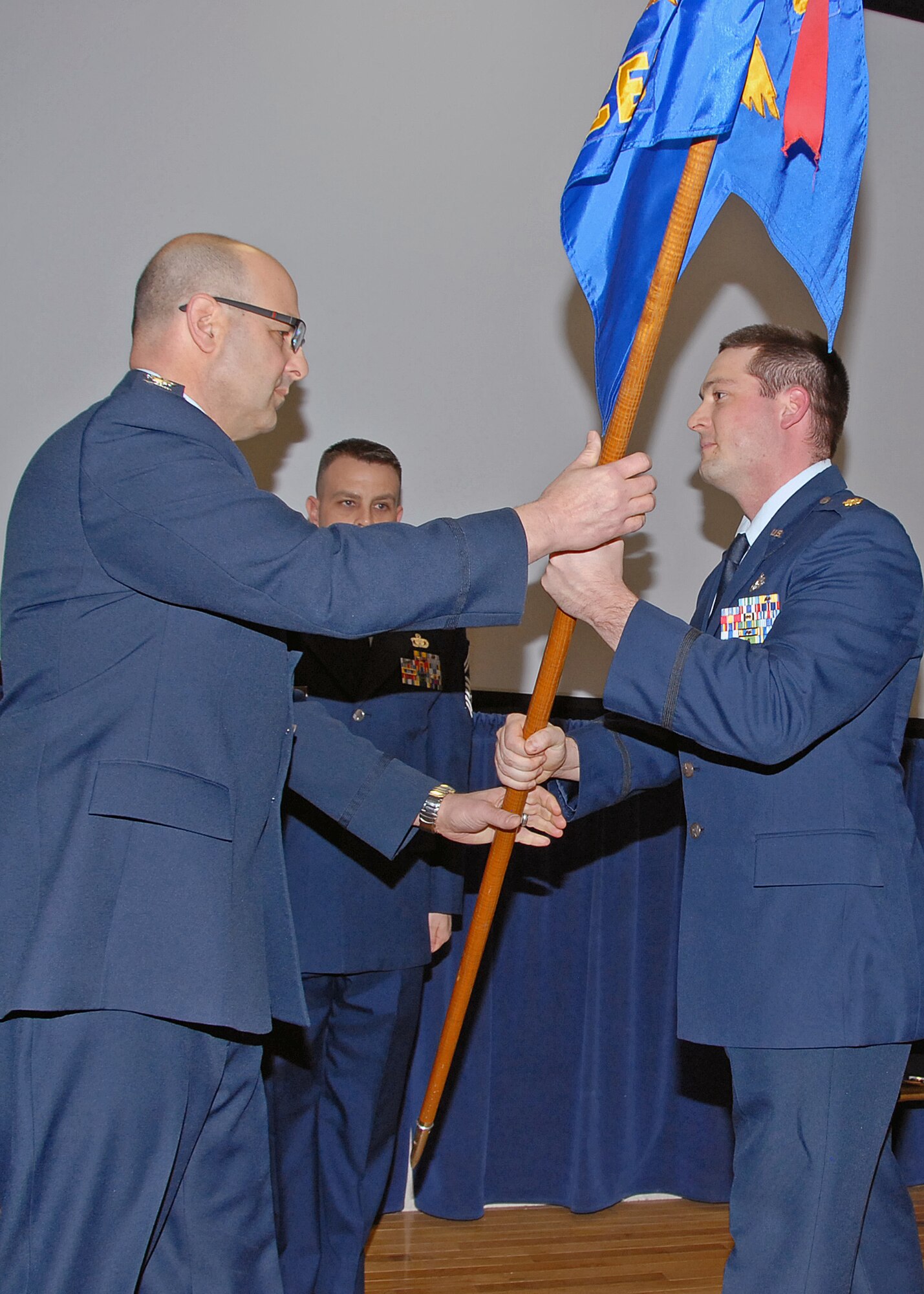 Major Jeremiah Buckenberger (right) assumes Command of the 143d Civil Engineering Squadron from Colonel Anthony Hamel, 143d Airlift Wing, Mission Support Group Commander during a ceremony held at Quonset Air National Guard Base, North Kingstown, Rhode Island on February 8, 2015. Outgoing 143d CES Commander, Lieutenant Colonel Kevin Bartlett, retired from the 143d Airlift Wing on February 7, 2015. National Guard Photo by Technical Sgt Jason Long (RELEASED)