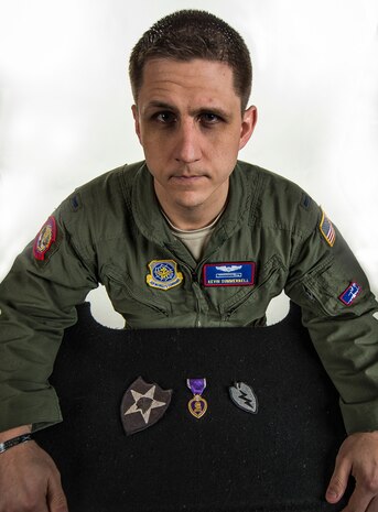 First Lt. Kevin Summerbell, 15th Airlift Squadron C-17 Globemaster III pilot, shows his Purple Heart and Army patches he kept from serving in the United States Army Feb. 19, 2015, at Joint Base Charleston, S.C. Summerbell later attended Officer Training School and commissioned as an officer in the Air Force to be a C-17 pilot, the same aircraft he was flown back on after being wounded in combat. (U.S. Air Force photo/ Senior Airman Dennis Sloan)