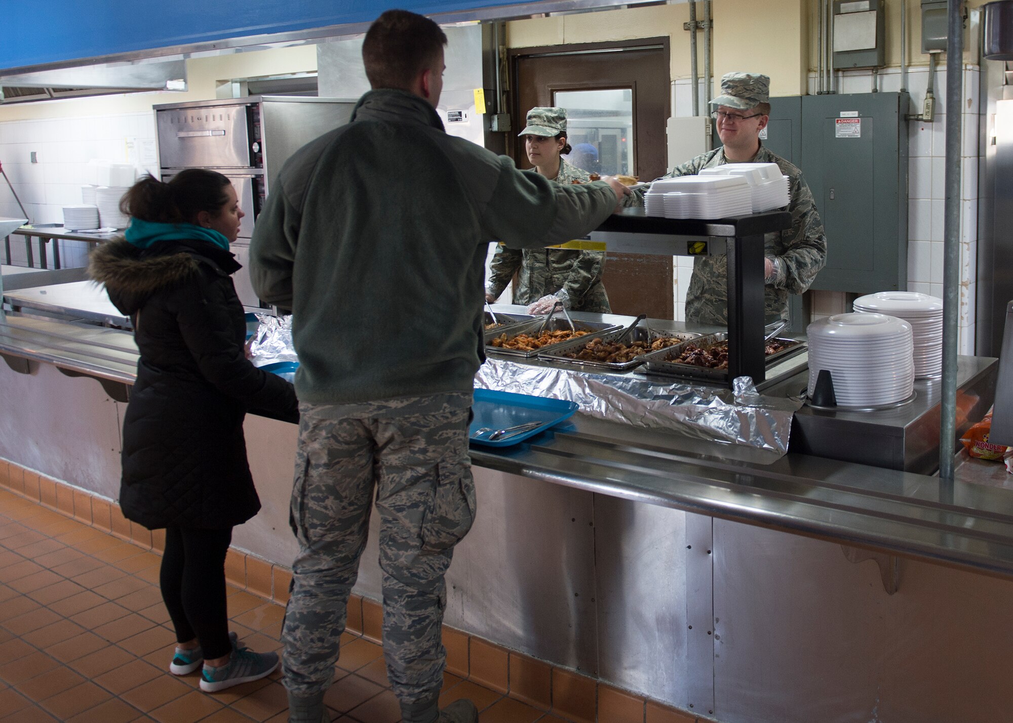 U.S. Air Force Airman 1st Class Nathan Weiss, an Illinois Air National Guard 183rd Force Support Squadron food service apprentice, works alongside Senior Airman Samantha Holt, a 51st FSS food service journeyman, during lunch March 4, 2015, at the Pacific House Dining Facility, Osan Air Base, Republic of Korea, during exercise Key Resolve. Working alongside U.S. Marines, local civilians and Air National Guard and Air Force Reserve Airmen provided a unique learning opportunity and a chance to share best practices. (U.S. Air Force photo by Staff Sgt. Shawn Nickel/Released)