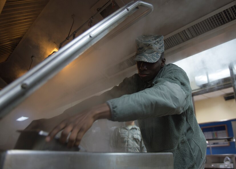 U.S. Air Force Airman 1st Class Robert Walker, a 51st Force Support Squadron food service journeyman, reaches deep into a steamer to remove vegetables prepared for lunch March 4, 2015, at the Pacific House Dining Facility, Osan Air Base, Republic of Korea, during exercise Key Resolve. Active-duty Airmen worked alongside Air National Guard and Air Force Reserve counterparts along with U.S. Marines and local civilians to provide total force integration. (U.S. Air Force photo by Staff Sgt. Shawn Nickel/Released)