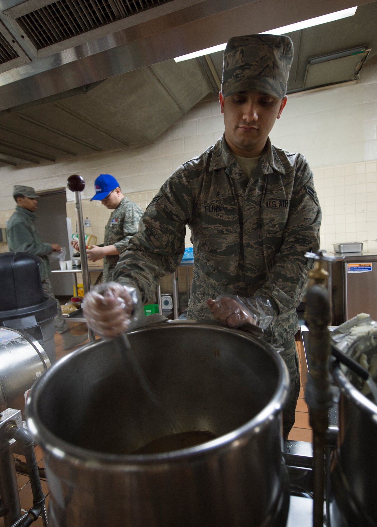 U.S. Air Force Airman 1st Class Andrew Flinn, an Illinois Air National Guard 183rd Force Support Squadron food service apprentice, makes wing sauce from scratch for "Wing Wednesday," March 4, 2015, at the Pacific House Dining Facility, Osan Air Base, Republic of Korea, during exercise Key Resolve. Active-duty Airmen worked alongside Air National Guard and Air Force Reserve counterparts along with U.S. Marines and local civilians to provide total force integration. (U.S. Air Force photo by Staff Sgt. Shawn Nickel/Released)
