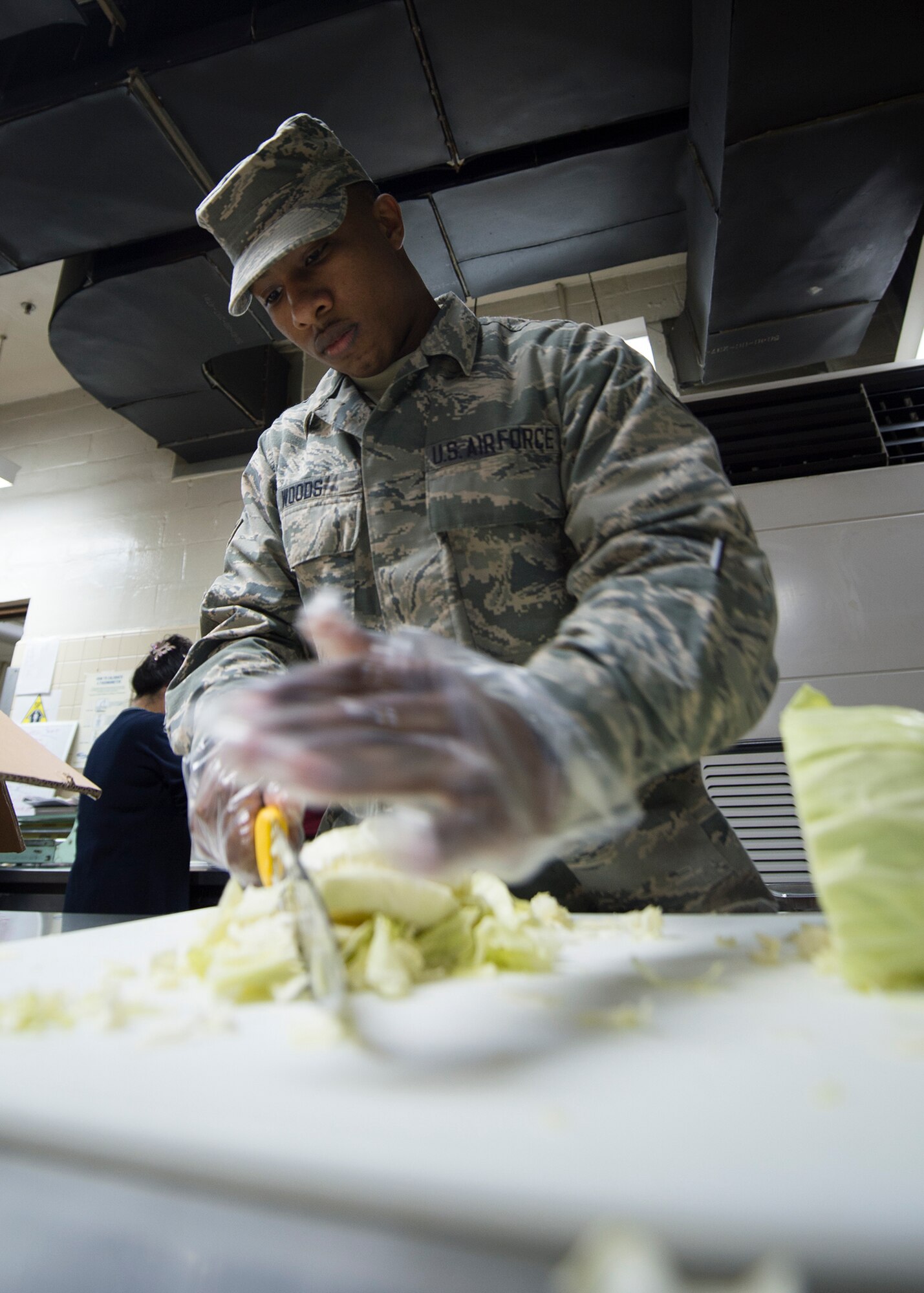U.S Air Force Airman 1st Class Drewnard Woods, an Illinois Air National Guard 183rd Force Support Squadron food service apprentice, chops cabbage while cooking lunch March 4, 2015, at the Pacific House Dining Facility, Osan Air Base, Republic of Korea, during exercise Key Resolve. Active-duty Airmen worked alongside Air National Guard and Air Force Reserve counterparts along with U.S. Marines and local civilians to provide total force integration. (U.S. Air Force photo by Staff Sgt. Shawn Nickel/Released)