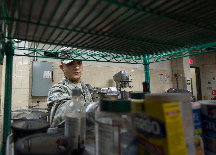 U.S. Air Force Airman 1st Class Andrew Flinn, an Illinois Air National Guard 183rd Force Support Squadron food service apprentice, collects spices to make wing sauce from scratch for "Wing Wednesday," March 4, 2015, at the Pacific House Dining Facility, Osan Air Base, Republic of Korea, during exercise Key Resolve. Active-duty Airmen worked alongside Air National Guard and Air Force Reserve counterparts along with U.S. Marines and local civilians to provide total force integration. (U.S. Air Force photo by Staff Sgt. Shawn Nickel/Released)