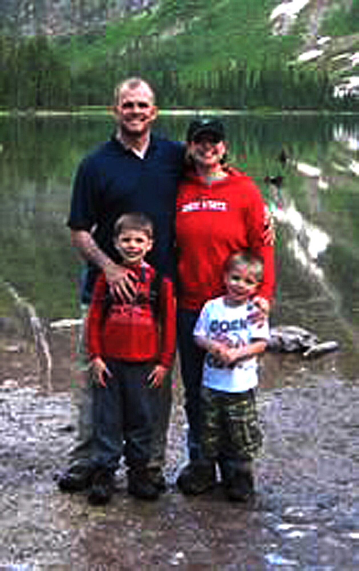 Col. Todd Sauls, 90th Operations Group commander, his wife Suzanne, and his children, Jackson and Williams, pose for a photo in front of a lake. The family goes hiking, hunting and fishing as a way to relax and spend time together. (U.S. Air Force courtesy photo)