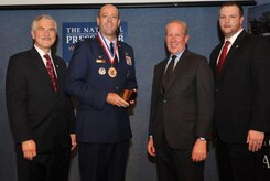 The National Society of Professional Engineers named Lt. Col. Patrick Miller, 628th Civil Engineer Squadron commander, as the nation’s top federal engineer during a ceremony Feb. 26, 2015 at the National Press Club in Washington, D.C.Standing (Left to right): NSPE President Harve D. Hnatiuk, P.E., F.NSPE; Lt. Col. Patrick Miller, P.E., U.S. Air Force; NSPE Executive Director Mark J. Golden, FASAE, CAE; and NSPE Board Member David Scott Wolf, P.E., PLS, F.NSPE. (Courtesy Photo / Christies Photography) 