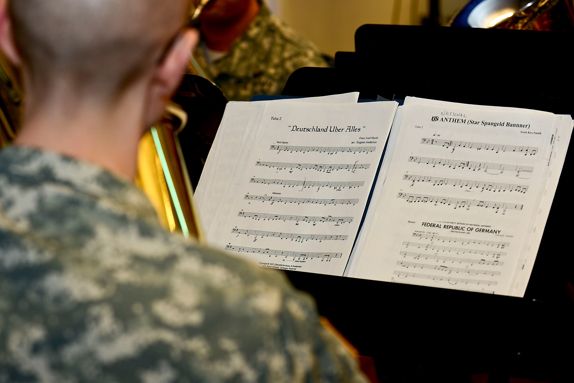 U.S. Army Staff Sgt. Daniel Aston, U.S. Army Training and Doctrine Command Band tuba player, plays the Federal Republic of Germany and the United States of America national anthems during the German Armed Forces Proficiency Badge award ceremony at Fort Eustis, Va., March 3, 2015. The TRADOC Tuba-Euphonium Quartet performed throughout the ceremony. (U.S. Air Force photo by Senior Airman Kimberly Nagle/Released)