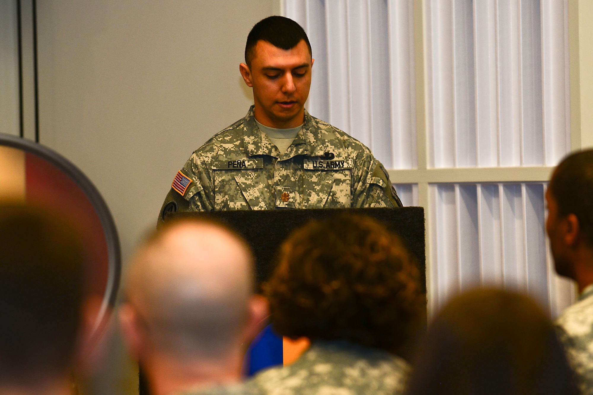 U.S. Army Maj. Leonel Pena, U.S. Army Training and Doctrine Command Band commander, speaks during the German Armed Forces Proficiency Badge award ceremony at Fort Eustis, Va., March 3, 2015. Pena spoke on the teamwork between the TRADOC Band and the TRADOC German Liaison Office during the competition for the badge. (U.S. Air Force photo by Senior Airman Kimberly Nagle/Released)