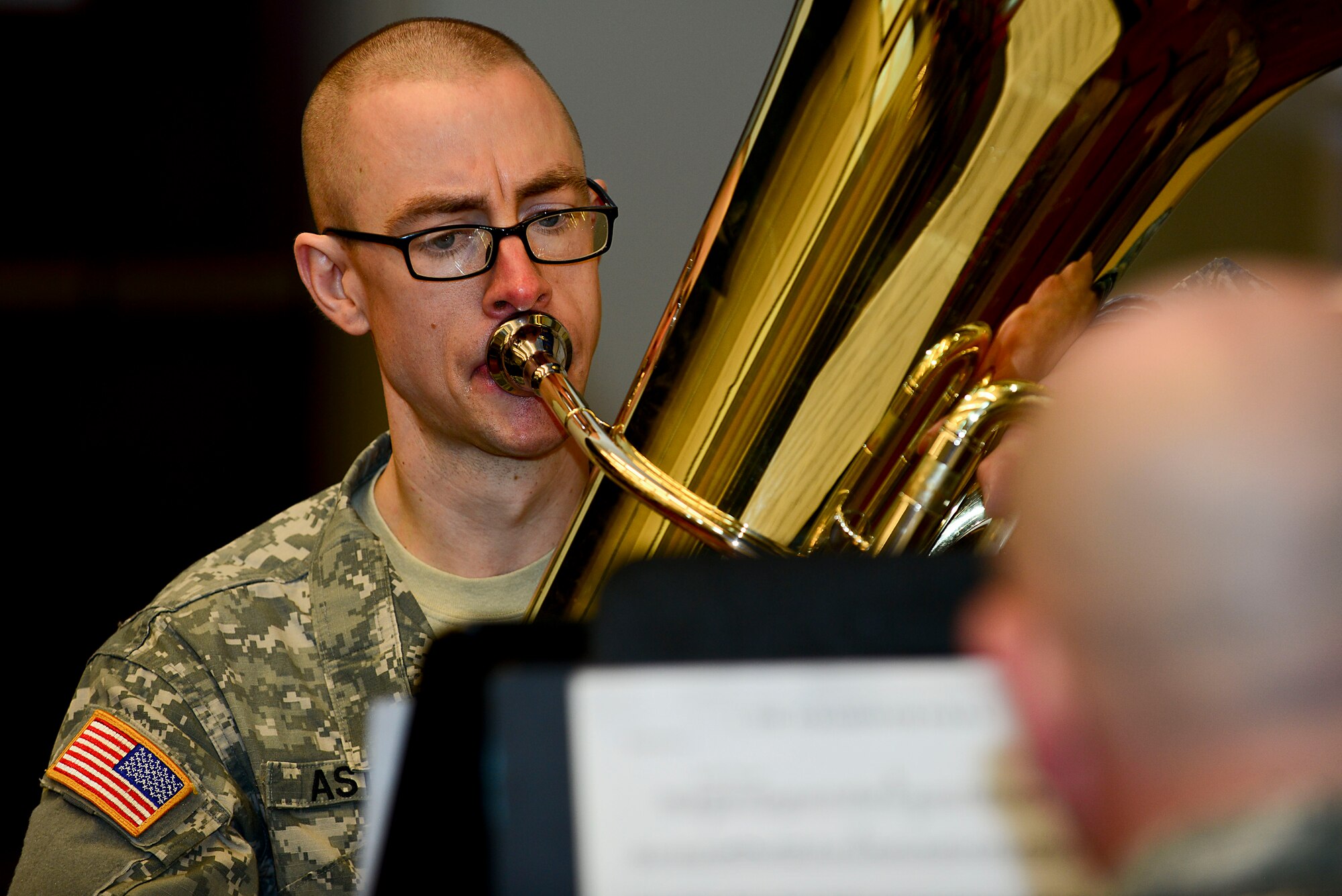 U.S. Army Staff Sgt. Daniel Aston, U.S. Army Training and Doctrine Command Band tuba player, performs during the German Armed Forces Proficiency Badge award ceremony at Fort Eustis, Va., March 3, 2015. Twenty Fort Eustis Soldiers were awarded the badge after competing in multiple events. (U.S. Air Force photo by Senior Airman Kimberly Nagle/Released)