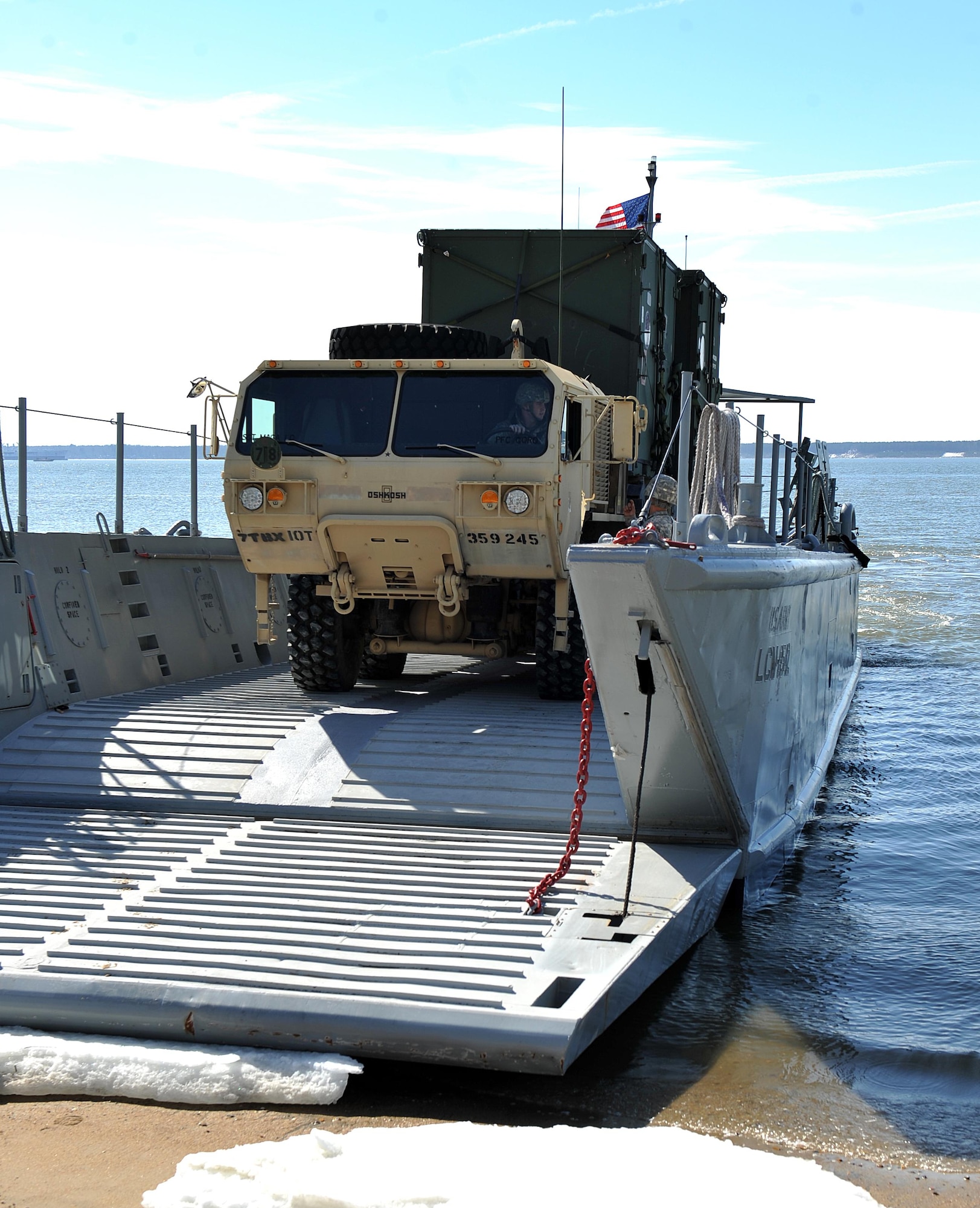 An LCM-6 "Mike Boat" prepares to unload an armored truck containing two ISU-90 cargo containers belonging to Joint Task Force Civil Support, during a Joint Logistics Over The Shore operation at Fort Eustis, Va., March 2, 2015. The units conducted rehearsals to ensure maximum preparedness for the upcoming JLOTS operation in the Pacific. (Department of Defense photo by Navy Petty Officer 2nd Class Benjamin T. Liston)