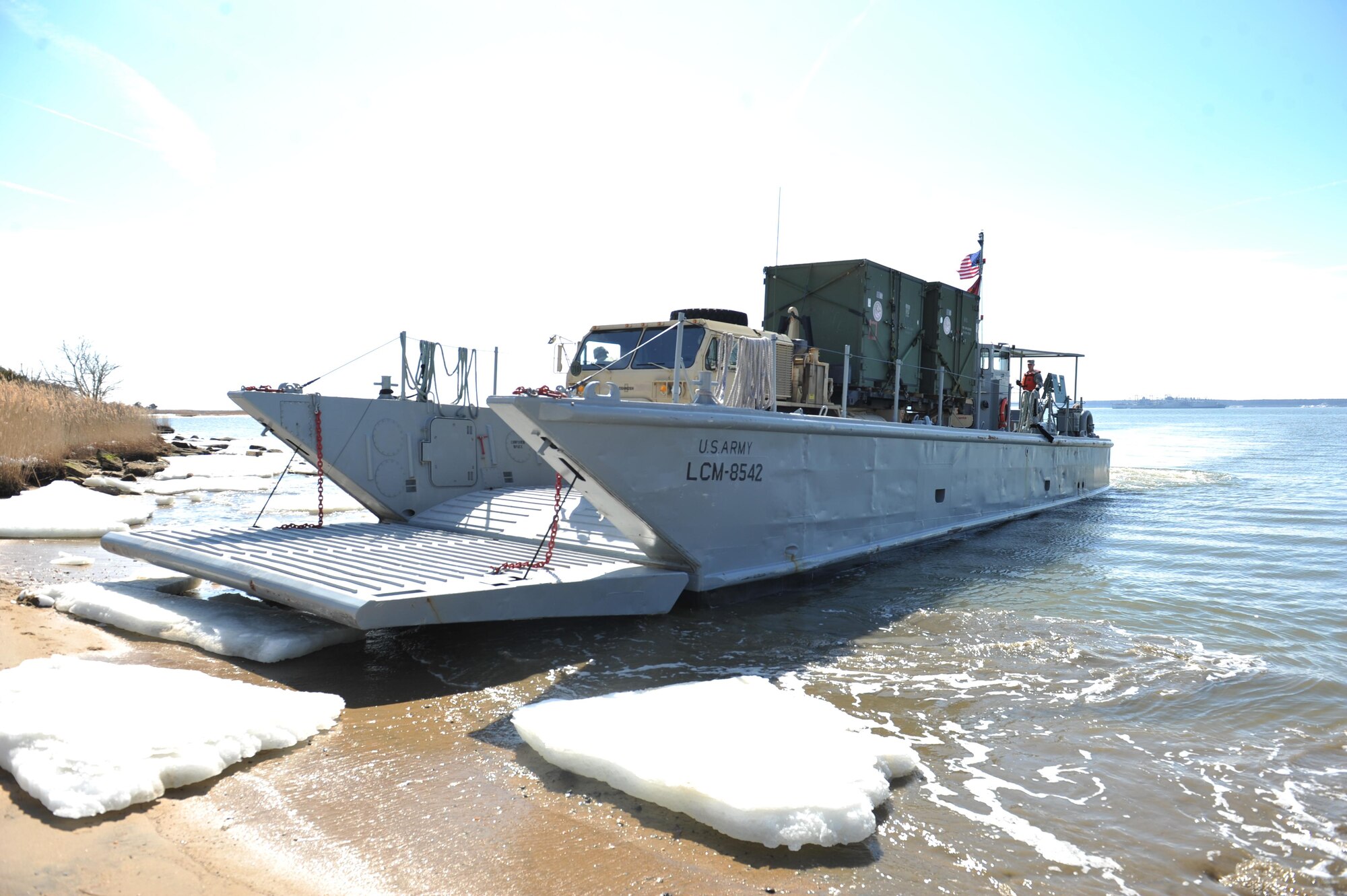 An LCM-6 "Mike Boat" prepares to unload an armored truck containing two ISU-90 cargo containers belonging to Joint Task Force Civil Support, during a Joint Logistics Over The Shore operation at Fort Eustis, Va., March 2, 2015. The JLOTS operation allowed units to validate their ability to perform their assigned task, identify any weakness and improve upon them at 3rd Port and Anzio Beach. (Department of Defense photo by Navy Petty Officer 2nd Class Benjamin T. Liston)