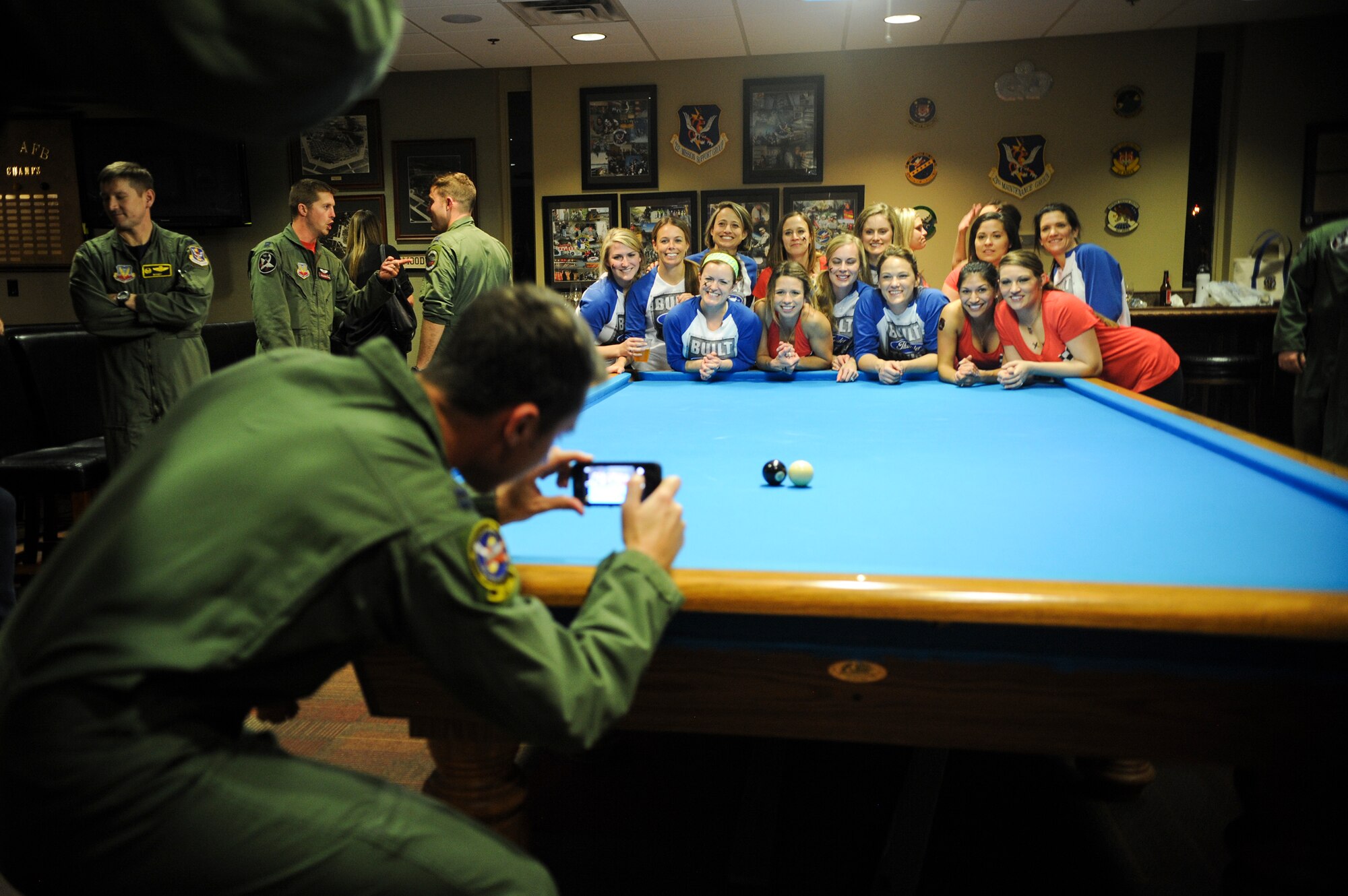 U.S. Air Force Capt. Ian Osterreicher, 74th Fighter Squadron A-10 pilot, takes a group photo of the 74th and 75th FS Crud teams after the Moody Air Force Base Annual Wives Crud Tournament Feb. 27, 2015, at Moody AFB, Ga. The 38th Rescue Squadron organized the eight-team double elimination tournament. (U.S. Air Force photo by Andrea Jenkins/Released)




