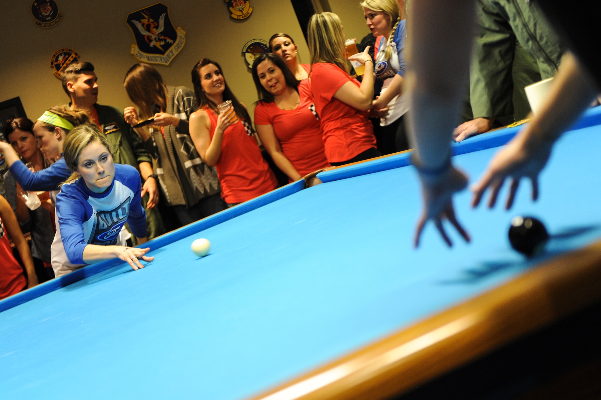 Hannah Knauss, wife of U.S. Air Force Capt. James Knauss, 74th Fighter Squadron, serves the ball during the Moody Air Force Base Annual Wives Crud Tournament Feb. 27, 2015, at Moody Air Force Base, Ga.  The Shooter or server is given three attempts to hit the black ball before they lose a life. Each of the five members of the crud team is given three lives before they are eliminated from the game. (U.S. Air Force photo by Andrea Jenkins/Released)


