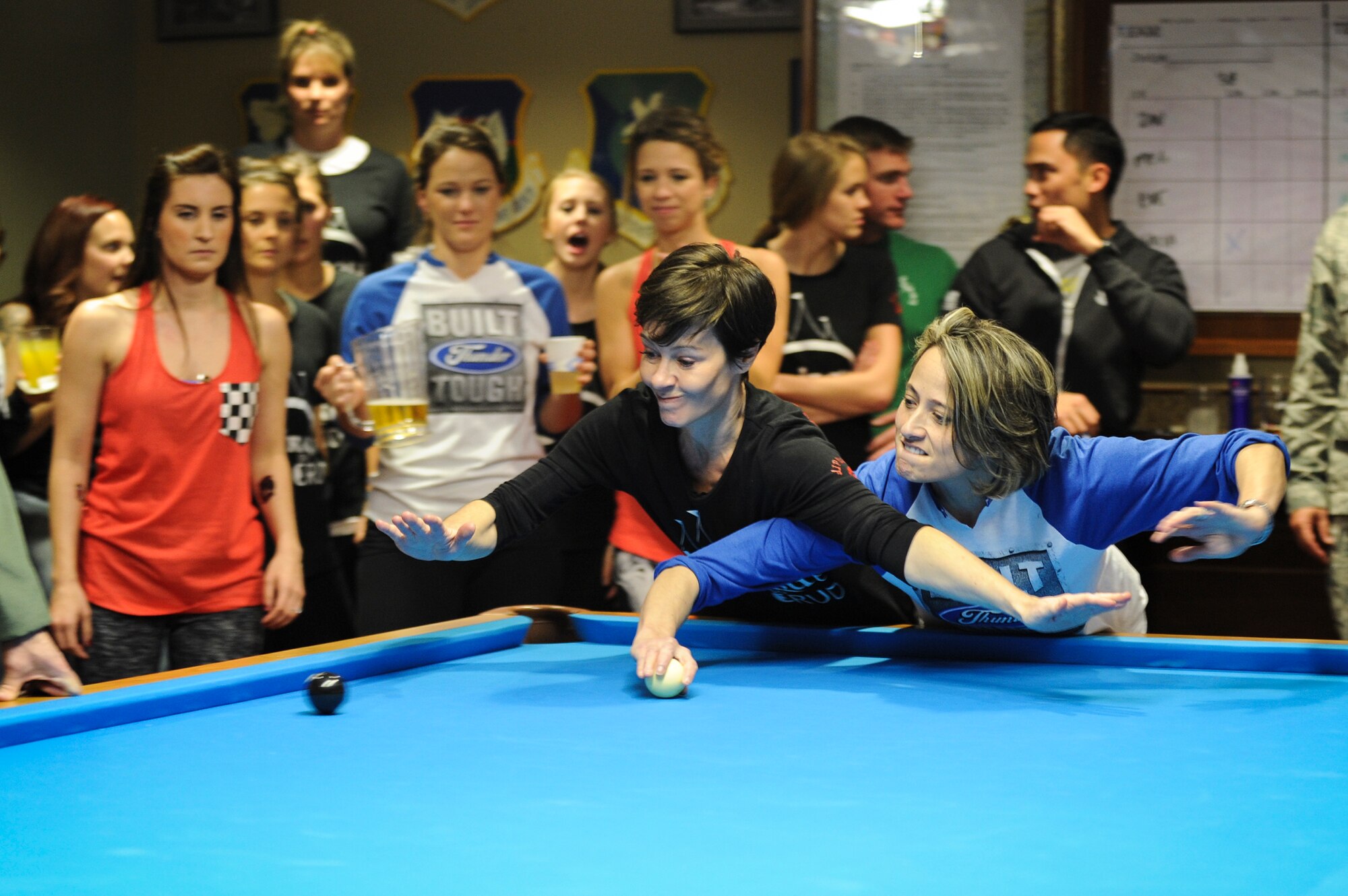 Alissa Boland (right), wife of U.S. Air Force Lt. Col. Patrick Boland, 23d Fighter Group, shoots through the defense of Meghan Barnard, wife of Maj. Joe Barnard, 38th Rescue Squadron commander, during the Moody Air Force Base Annual Wives Crud Tournament Feb. 27, 2015, at Moody AFB, Ga.  Barnard, the 38th RQS’s Crud team captain, was the reigning champion and tournament organizer. (U.S. Air Force photo by Andrea Jenkins/Released)


