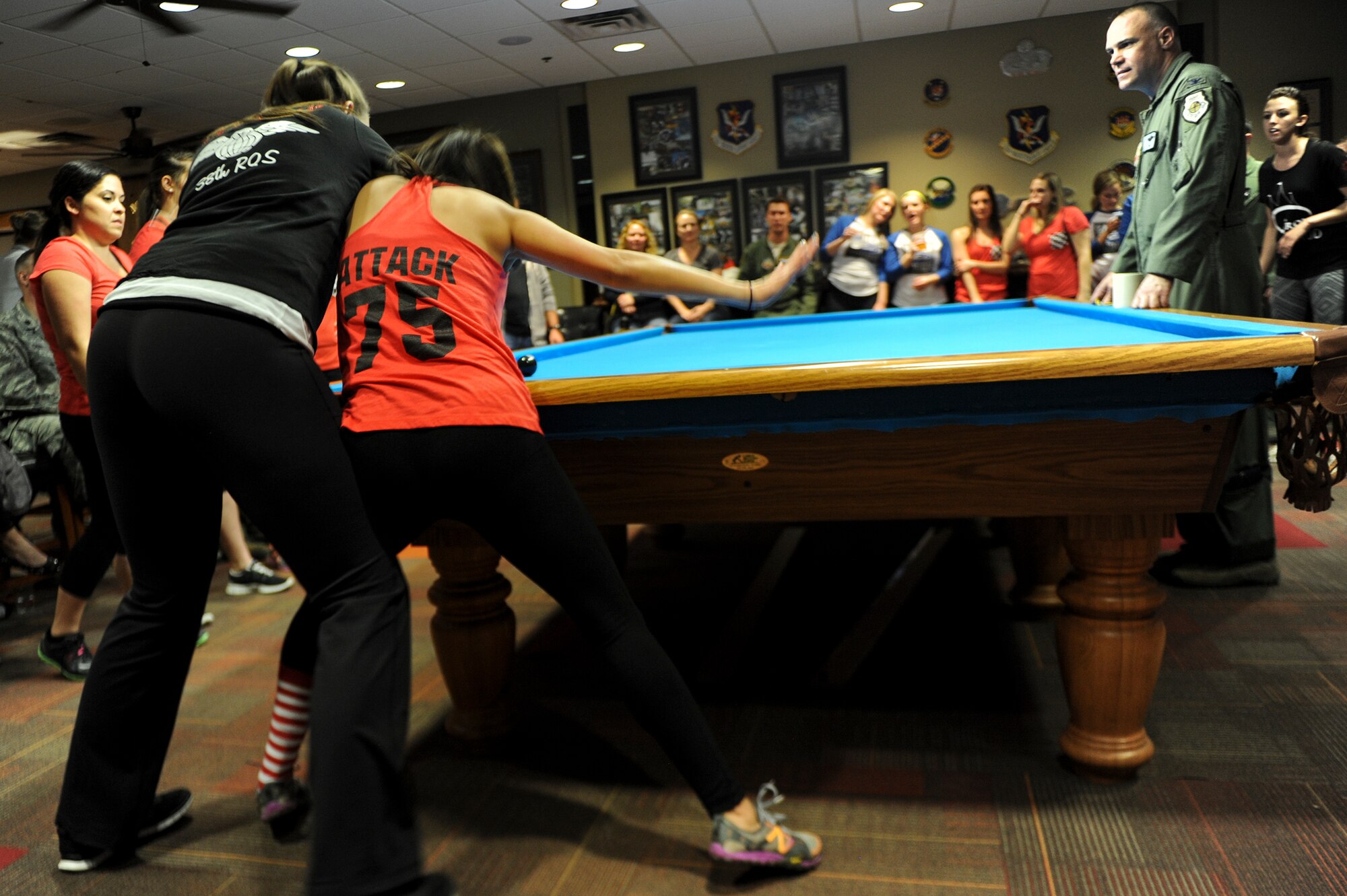 Stephanie Seibert (right), wife of U.S. Air Force Capt. Shane Seibert, 75th Fighter Squadron, defends her position against 38th Rescue Squadron spouse’s Crud team member Talia Pole, during the Moody Air Force Base Annual Spouses Crud Tournament Feb. 27, 2015, at Moody AFB, Ga. Seibert and the 75th crud team ultimately won the tournament and bragging rights. (U.S. Air Force photo by Andrea Jenkins/Released)
