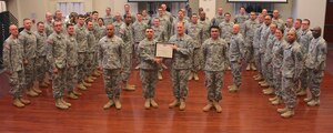 U.S. Army Maj. Gen. Rex Spitler, U.S. Army Training and Doctrine Command deputy chief of staff, presents the Col. George S. Howard Citation of Musical Excellence for Military Concert Bands to Maj. Leonel Pena, TRADOC Band commander, and the band during a presentation at Fort Eustis, Va., March 2, 2015. The citation is an annual award presented to military concert bands across the globe who have demonstrated significant high standards of musical excellence. (U.S. Army photo by Staff Sgt. Jose Pomales Alvarez/Released)