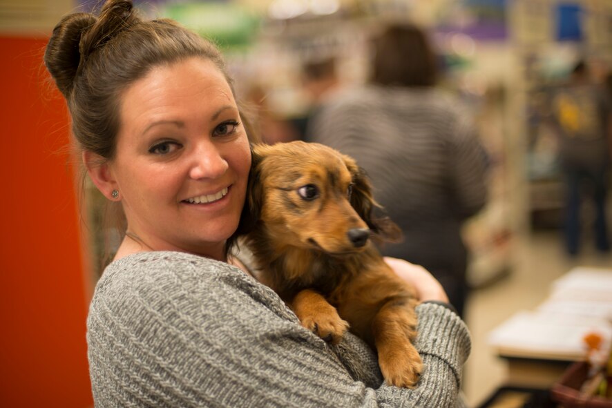U.S. Air Force Senior Airman Tara Thompson, 23d Security Forces confinement officer, poses for a photo with Charlie, a local rescue dog, at a local pet store Jan. 31, 2015, in Valdosta, Ga. Thompson’s volunteer group, the Moody Pet Guardian Angels, helps find homes and fosters for deployed Airmen’s animals and rescues. (U.S. Air Force photo by Airman 1st Class Dillian Bamman/Released)