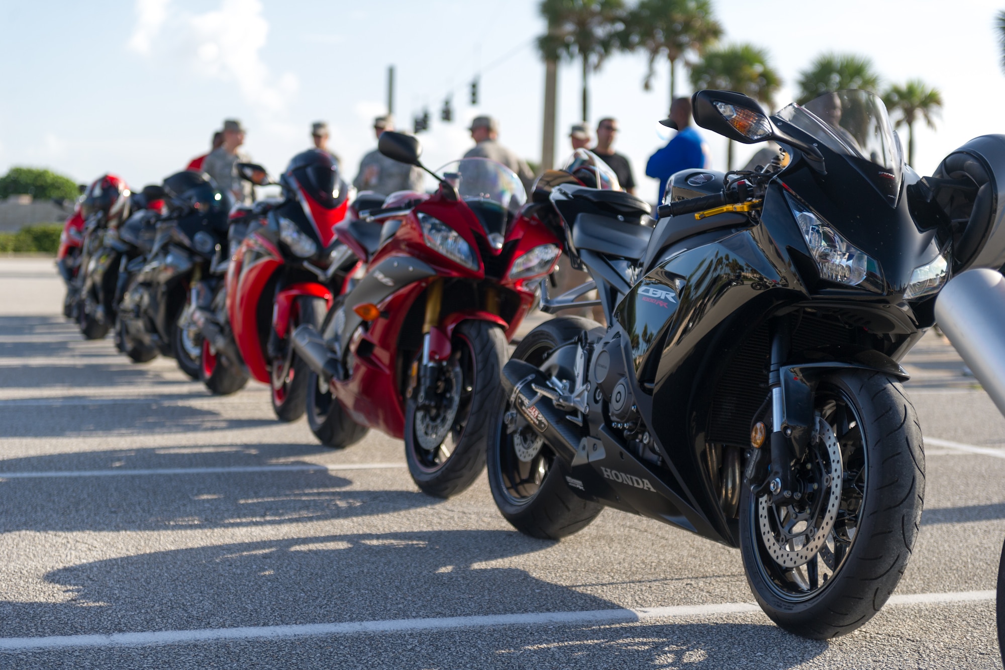 A row of motorcycles stand ready for riders during a recent motorcycle mentorship ride at Patrick Air Force Base, Fla.  Motorcycle mentorship rides are designed to help less experienced motorcycle riders learn from experienced riders during group rides. (U.S. Air Force photo/Cory Long) (Released)