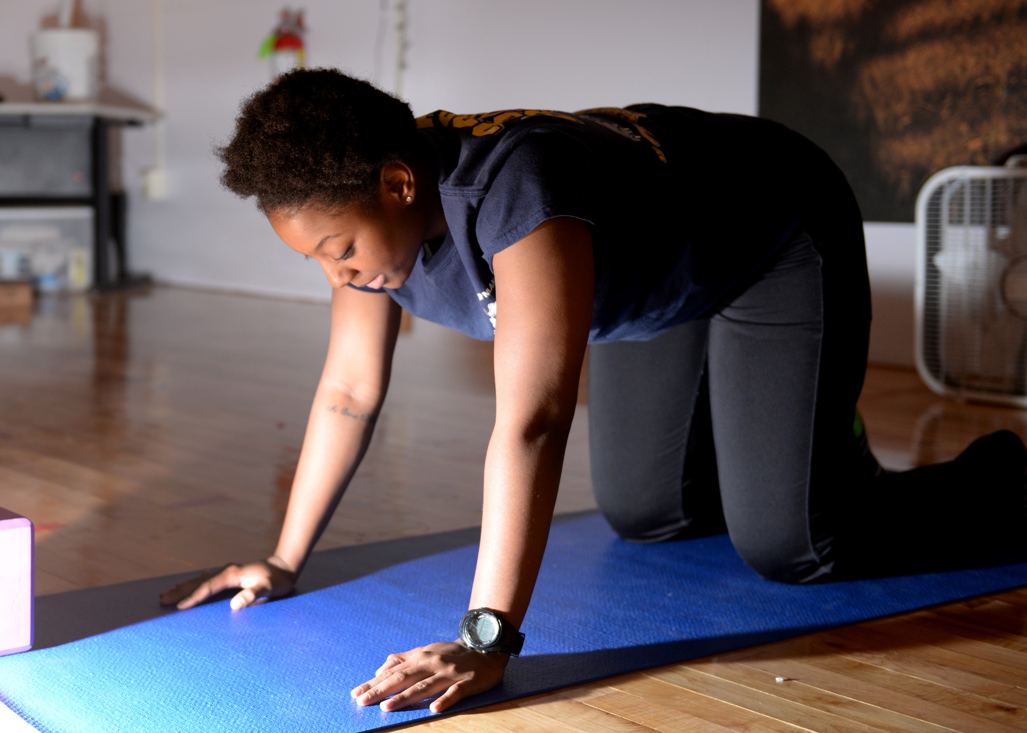 ALTUS AIR FORCE BASE, Okla. – U.S. Air Force Airman 1st Class Vinecia Anderson, 97th Medical Operations Squadron dental assistant, participates in a Yoga Unwind class at the base fitness center, March 3, 2015. Yoga Unwind is a new yoga class specifically designed to build balance between mind and body through gaining strength and stability. The class is being held in the spin room of the base gym Tuesday and Thursday nights at 7:30 p.m. (U.S. Air Force photo by Airman 1st Class J. Zuriel Lee/Released)