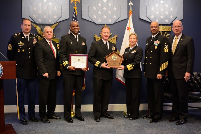 The Navy Operational Support Center Charleston, North Charleston, S.C., received the 2014 Reserve Family Readiness Award from the Principle Deputy Assistant Secretary of Defense for Reserve Affairs, Richard O. Wightman Jr., the President and CEO of the Military Officers Association of America, Vice Adm. (ret) Norb Ryan, and the senior enlisted advisor to the Under Secretary of Defense for Personnel and Readiness, Sgt. Maj. Michael D. Schultz at a ceremony Feb. 27, 2015 at the Pentagon's Hall of Heroes. (left to right: Sgt. Maj. Michael Schultz, Mr. Richard O. Wightman Jr., Cmdr. Stephen Jones, Cmdr. Shaun Murphy, Vice Adm. Robin Braun, Force Master Chief CJ Mitchell, Vice Adm. (ret) Norb Ryan) (Photo by Steve Turner, Office of the Assistant Secretary of Defense, Reserve Affairs)