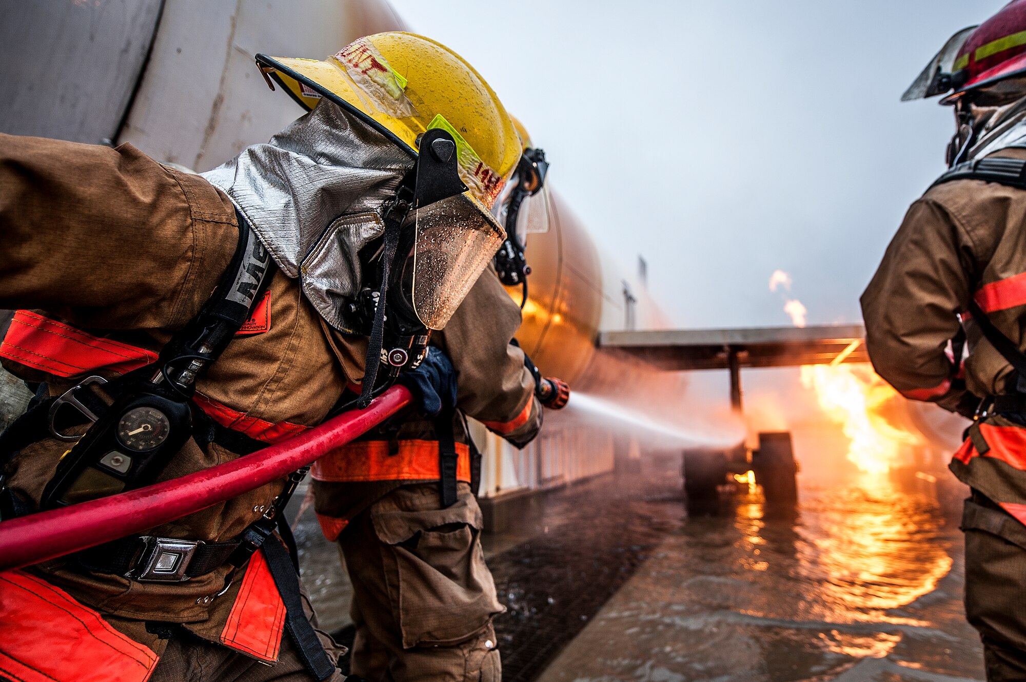 GOODFELLOW AIR FORCE BASE, Texas – Airman 1st Class Brooke D. Hunt, 177th Fighter Wing New Jersey Air National Guard firefighter apprentice, assists her classmate in extinguishing a C-130 fire during a training exercise at the Louis F. Garland Department of Defense Fire Academy Feb. 3. Hunt plans to make firefighting a career outside of the Air Force. (U.S. Air Force photo/ Airman 1st Class Devin Boyer)