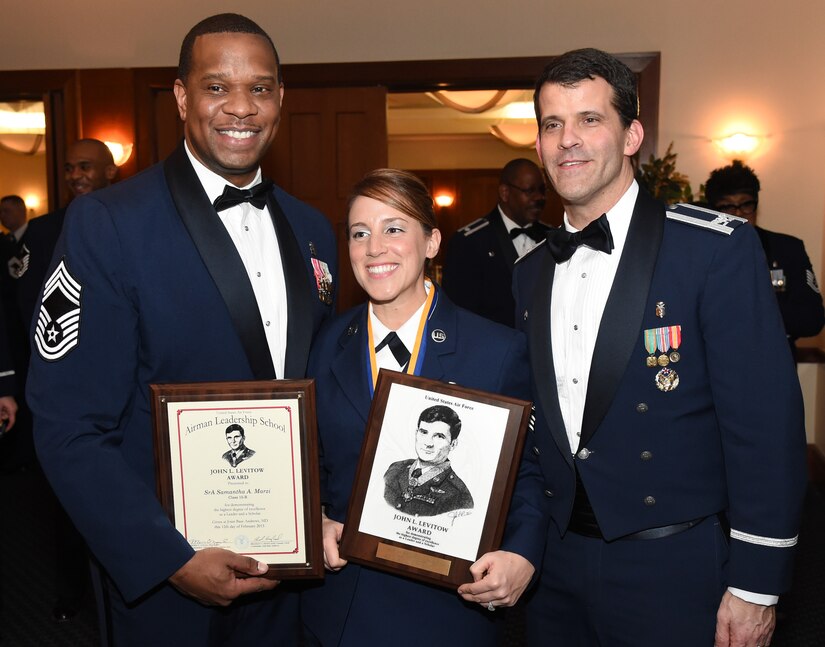 779th Medical Group Superintendent Chief Master Sgt. Tracy Washington and 779th Medical Group Commander, Col. Thomas Cantilina congratulate Senior Airman Samantha Marzi, from 779th Medical Group Medical Support Squadron for receiving the John L. Levitow Award during Airman Leadership School Class Graduation on Feb. 12 at Joint Base Andrews. The Levitow award is given for a student's exemplary demonstration of excellence, both as a leader and a scholar. 