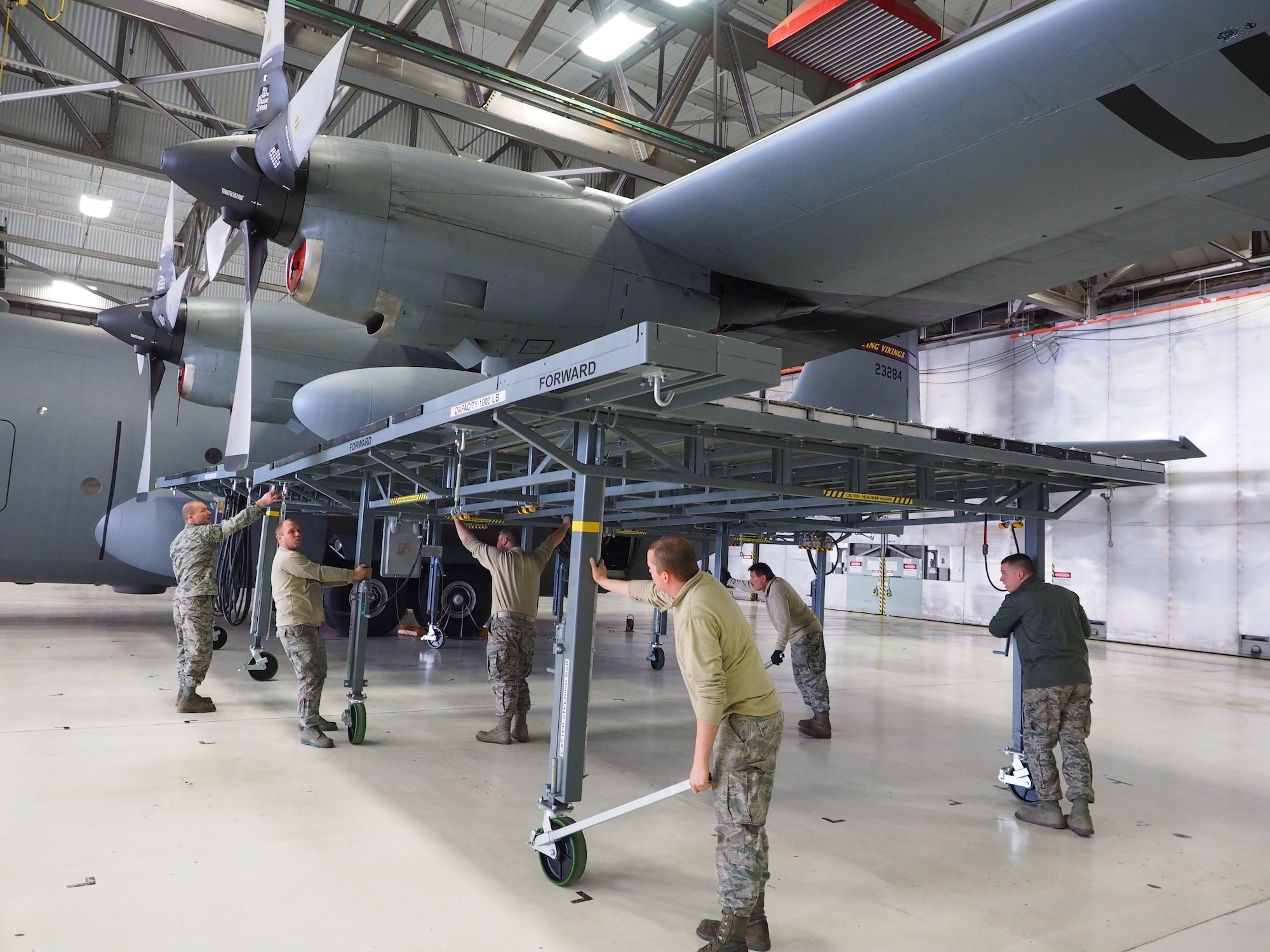 934th Airlift Wing maintainers position sections of the new ISO stand around a C-130. (Air Force Photo/Paul Zadach)
