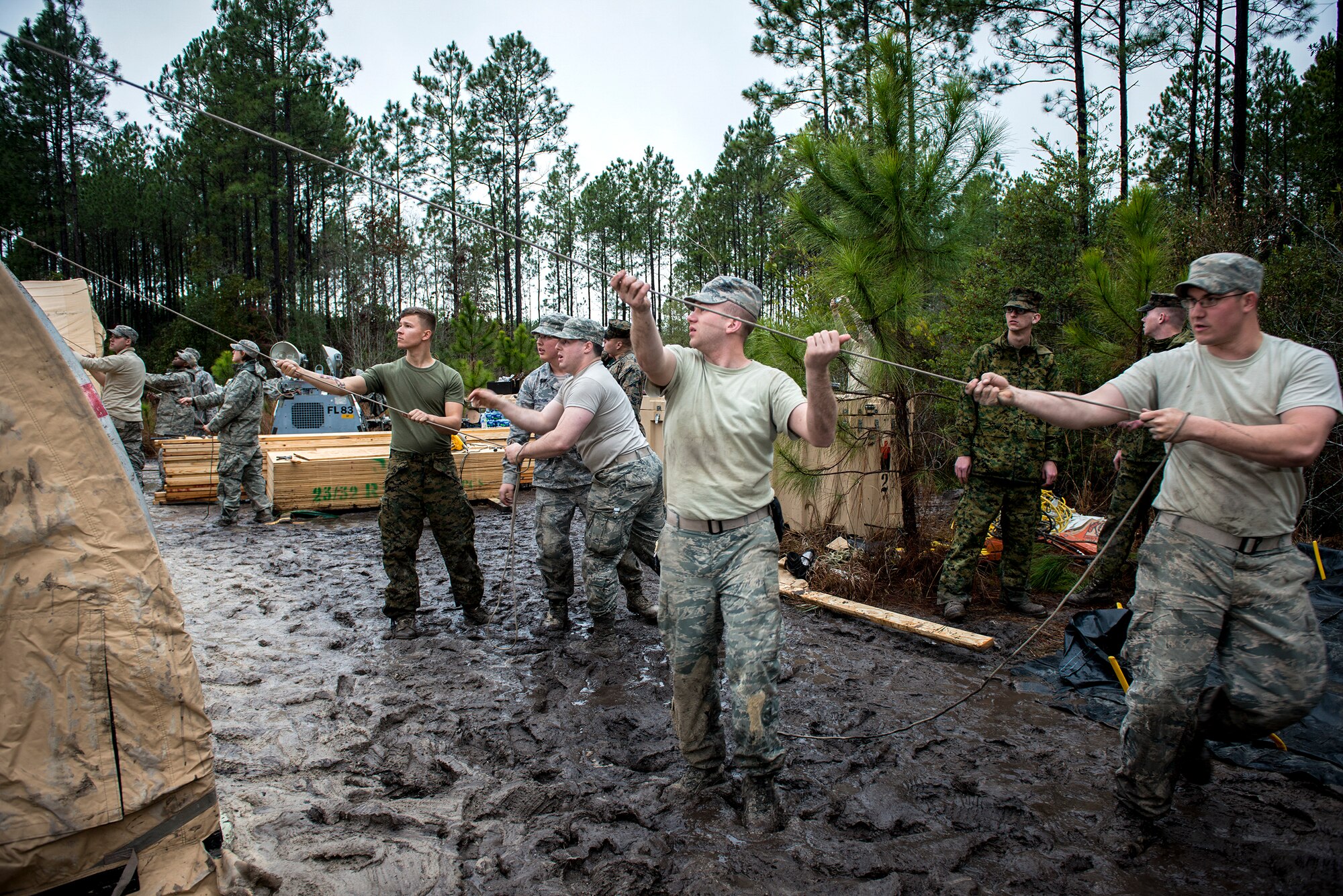 Airmen from the 23d Civil Engineer Squadron and Marines from Marine Corps Air Station Beaufort, S.C., build a command post Feb. 24, 2015, near Statenville, Ga. Marines from MCAS Beaufort are set to use the command post carry out a recovery mission following an F/A-18D Hornet assigned to MCAS Beaufort. (U.S. Air Force photo by Senior Airman Sandra Marrero/Released)
