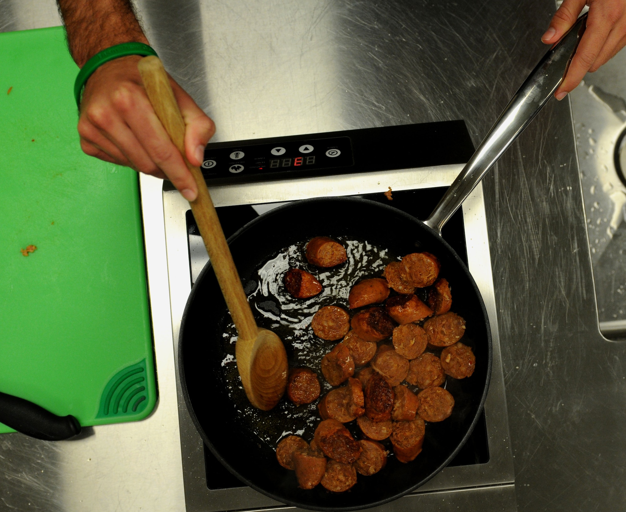 Andouille sausage cooks in a skillet before being added to a roux made of butter, onions, bell peppers, celery and garlic during a gumbo cooking class held by the 81st Force Support Squadron’s Single Airman Program Feb. 26, 2015, at the Mississippi Gulf Coast Community College, Perkinston, Miss. Traditionally served with andouille sausage and shrimp, gumbo’s versatility allows almost any meat to be added or substituted to the stew. (U.S. Air Force photo by Airman 1st Class Duncan McElroy) 