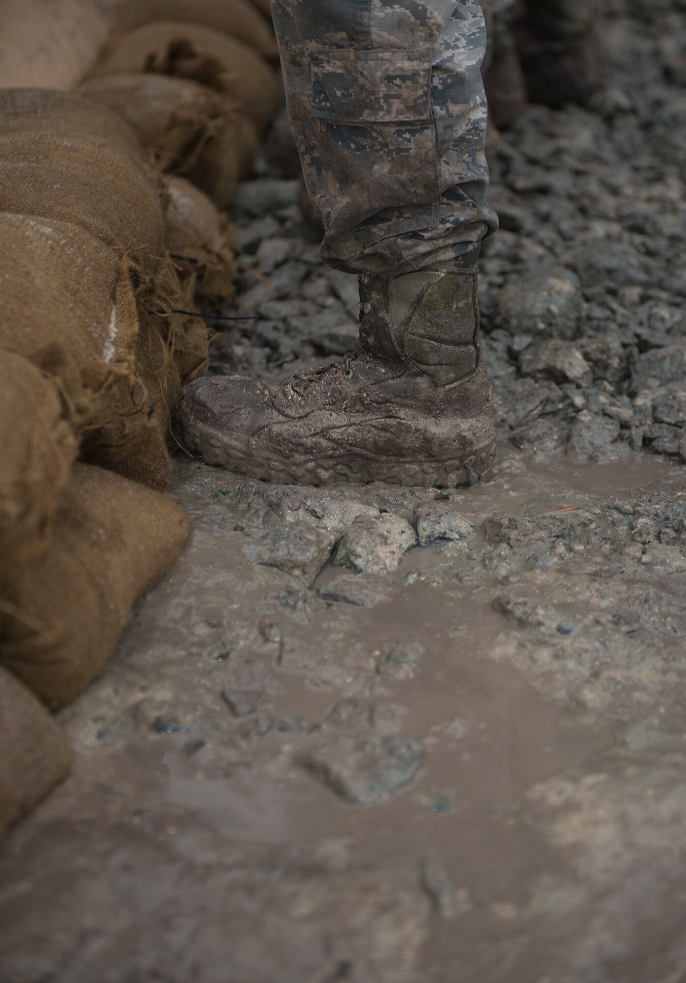 A 23d Civil Engineer Squadron Airman stacks sandbags while building a command post Feb. 24, 2015, near Statenville, Ga. Marines and Airmen collaborated to search for wreckage, construct the command post and provide the public with information following an F/A -18D Hornet accident.(U.S. Air Force photo by Senior Airman Sandra Marrero/Released)
