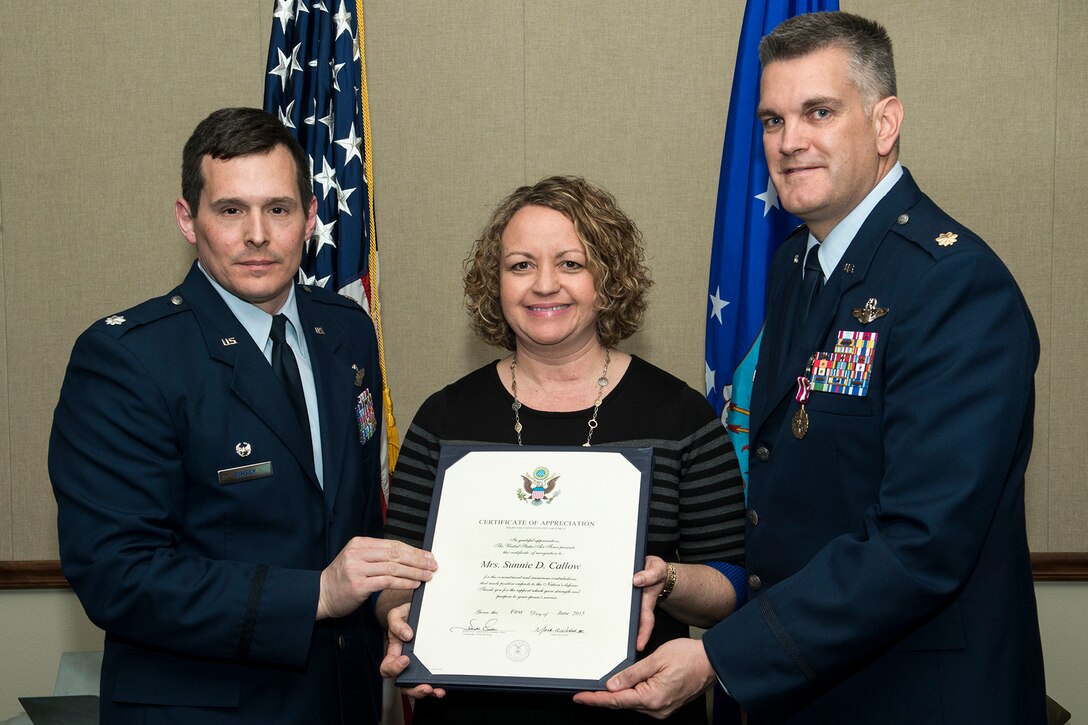 Sunnie Callow is presented a Certificate of Appreciation during a retirement ceremony held for her husband, U.S. Air Force Maj. Matthew Callow, on Feb. 27, 2015, Barksdale Air Force Base, La. Callow is a B-52H Stratofortress pilot assigned to the 11th Bomb Squadron and is retiring after 20 years of service. (U.S. Air Force photo by Master Sgt. Greg Steele/Released)