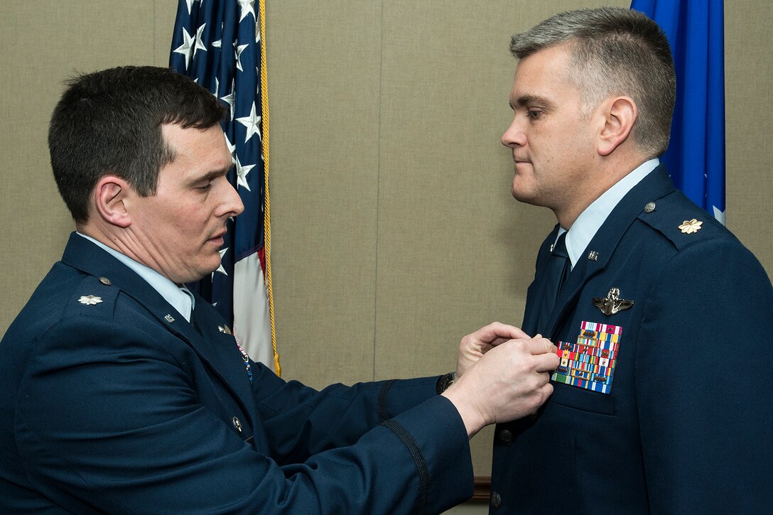U.S Air Force Lt. Col. Michael Rimsky, 11th Bomb Squadron commander, presents the Air Force Meritorious Service Medal to Maj. Matthew Callow during a retirement ceremony on Feb. 27, 2015, Barksdale Air Force Base, La. Callow received the medal for outstanding service to the United States as Chief of Safety while assigned to the 11th Bomb Squadron, and he is retiring from the Air Force after 20 years of service. (U.S. Air Force photo by Master Sgt. Greg Steele/Released)