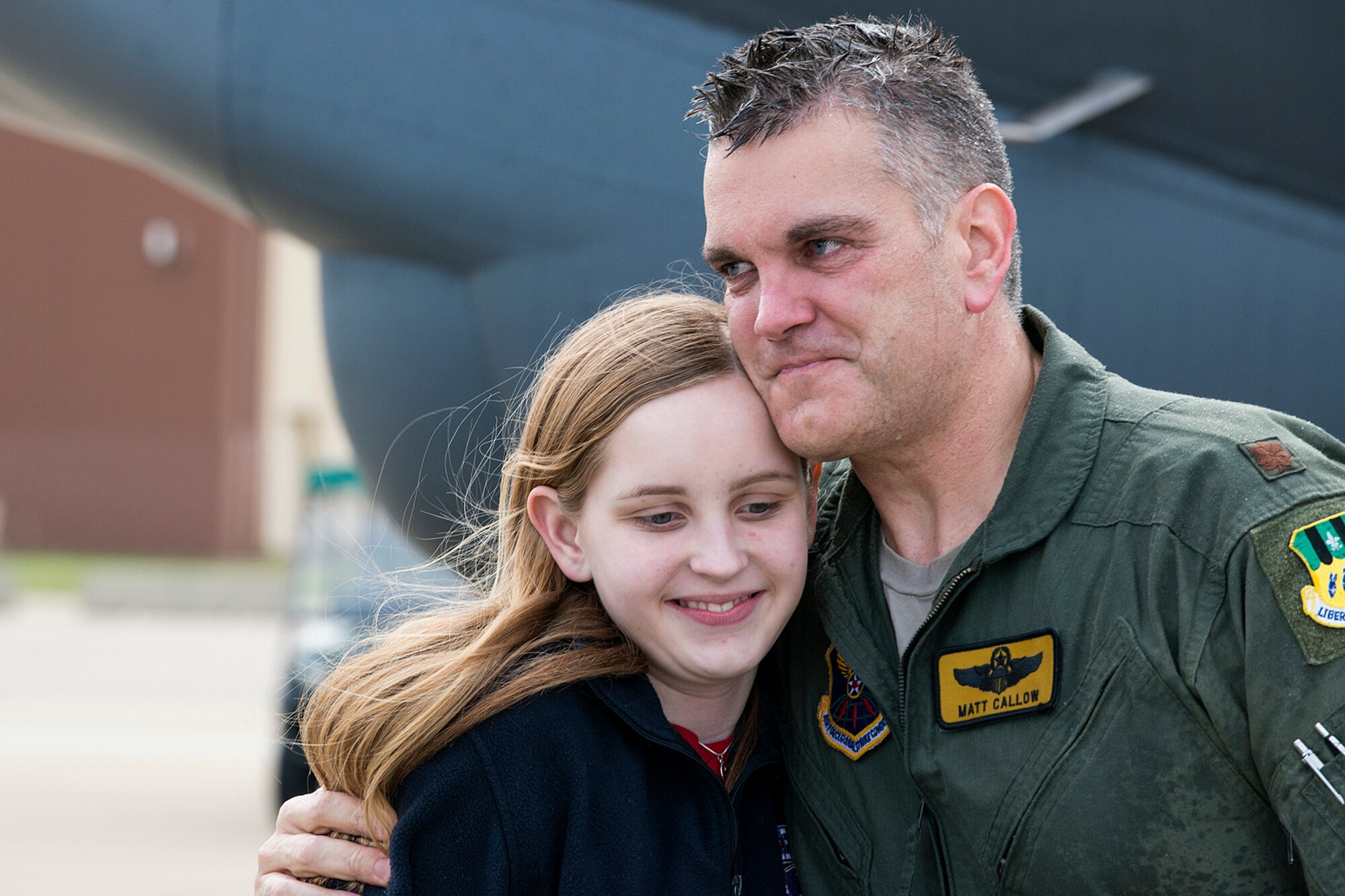 U.S. Air Force Maj. Matthew Callow gets a hug from his daughter, Chloe, after returning from his last flight in a B-52H Stratofortress, Feb. 5, 2015, Barksdale Air Force Base, La. Callow is a B-52 pilot assigned to the 11th Bomb Squadron and is retiring after 20 years of military service. (U.S. Air Force photo by Master Sgt. Greg Steele/Released)