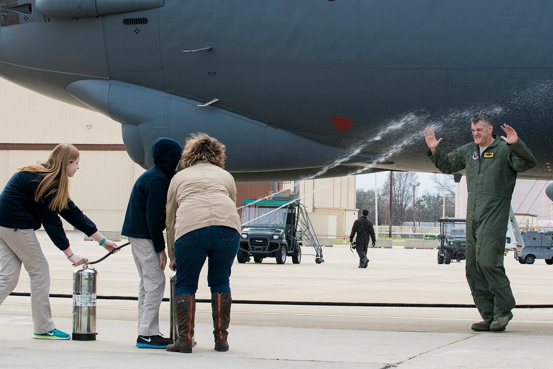 U.S. Air Force Maj. Matthew Callow gets hosed down after returning from his last flight in a B-52H Stratofortress, Feb. 5, 2015, Barksdale Air Force Base, La. Callow, a B-52 pilot, is retiring from the Air Force after 20 years of service. (U.S. Air Force photo by Master Sgt. Greg Steele/Released)