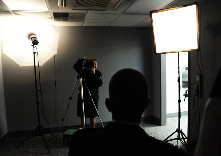 Airman 1st Class Alexa Culbert, 42nd Air Base Wing Public Affairs photojournalist, takes an official photo of Capt. Rajesh Mathew, 42nd Air Base Wing Judge Advocate chief military justice, Feb. 27, 2015, at the Maxwell Air Force Base photo lab.  On average, the photo lab produces more than 17,000 photos every year.  In addition, Culbert writes and takes photos for base news articles and social media pages. (U.S. Air Force phot by Staff Sgt. Joseph Park/Cleared)